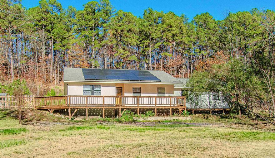 This home has it all and living off the grid.  Four bedrooms, two and a half baths, office, oversized Den, eat in kitchen, formal dining room, split bedroom plan and an oversized interior storage/pantry area.  Live off the grid with a well, propane tank and solar panals.  All this sitting on one acre.  Close to the city but fells like in the country.  Wood like LVP throughout for low maintance living.  Updated kitchen and baths!  Call me to see it today!