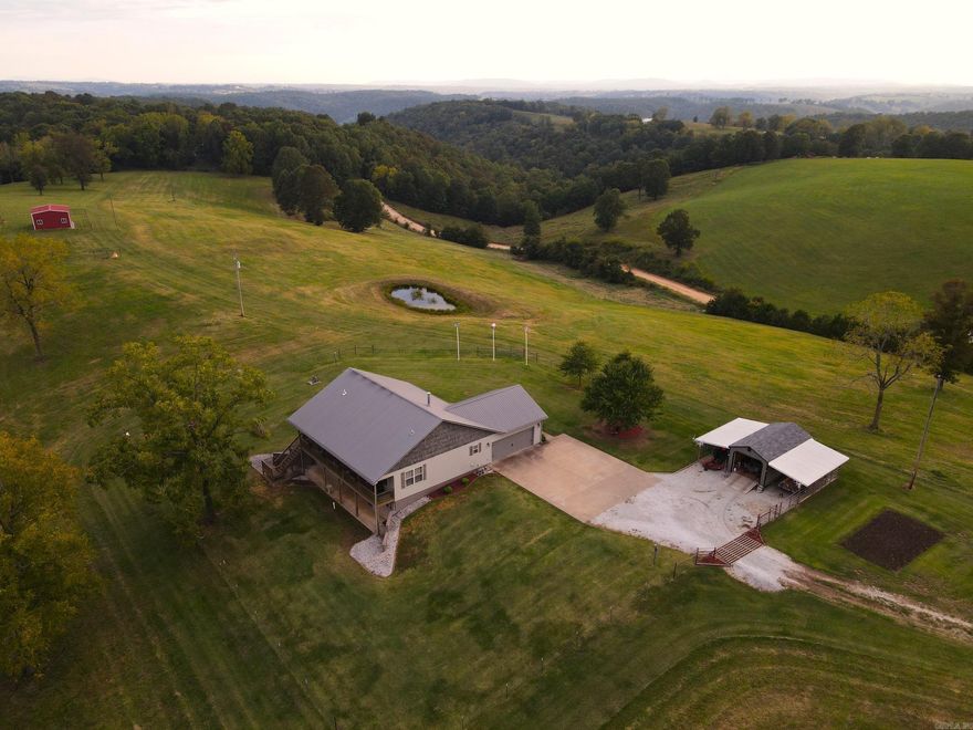 What a stunning setting tucked in a beautiful tract of land in the heart of the Ozarks just minutes from town and all the amenities you need. This four-bedroom/three-bathroom 2892 sq. ft. custom home is loaded with features and an irreplaceable location! Located just ¼ mile off the paved county road, you are greeted with rolling hills, lush pastures, hay meadows, and established large timber that creates a parklike setting. Setting atop the hill in the middle of your oasis is the impeccably built, roomy custom country home. The warm tones, private setting, huge covered back deck, plentiful storage, and established landscaping all combine to create an inviting atmosphere you’ll call home from the minute you pull up. The custom features are endless, and the details were well thought out, from the large open concept to the custom kitchen features. The charm of this country home peels the layers of stress from this crazy world the second you enter the door. Recently updated flooring, paint, new HVAC system, appliances, and more… The vinyl plank and custom tile floors are immaculate and set the mood with warm tones and neutral colors throughout the entire home.