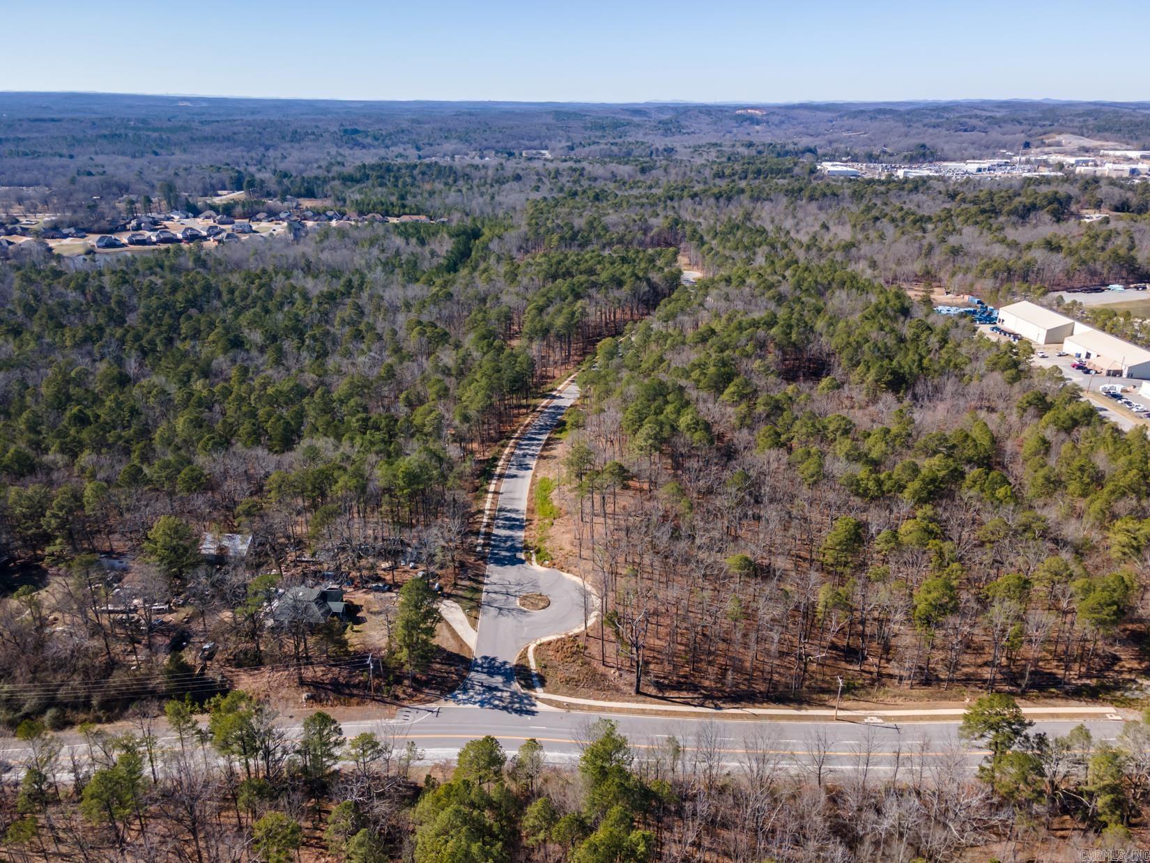 Developer Opportunity to create a residential neighborhood and/or multi-use commercial and residential neighborhood on 51 acres located in West Little Rock with engineering and planning by Joe White offering city utilities of water, sewer, electricity and gas. Plans exist to develop over 185 fifty foot wide residential homesites (similar to Waters Edge neighborhood) if desired. Topography of the land is very similar to Waters Edge with flat land and gentle slope (no steep or sharp inclines). Phase 1 infrastructure has been completed on 13 acres including the clearing of land, street installed with curbs and sidewalk accessed off Shackleford. If desired, a small portion of the land has city approval for re-zoning to commercial (was originally zoned residential). This property has additional access points to Waters Edge. Seller will consider splitting the land into two parcels and selling separately.
