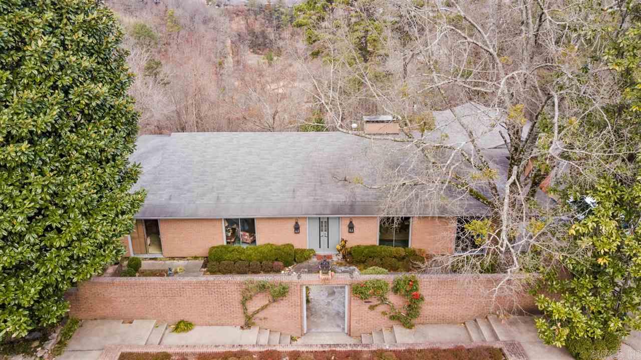 Mid-Centrury modern one level brick home with River view in desirable secluded neighborhood in the Heights. One owner custom built in 1960. Landscaped front courtyard with water feature. Formal dining, Living room, study, and den in Main house with 4 bedrooms, 3 baths (2553 SF). Kitchen with walk in pantry access to basement. Laundry, Guest quarters has 1 bedroom & 1 bath (421 SF). New wood deck with views of River and private backyard.