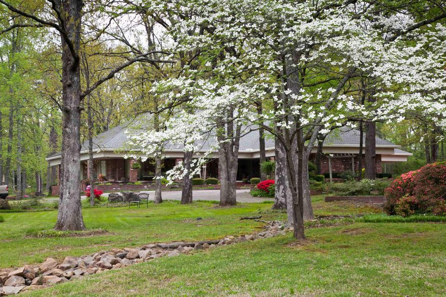 4-bedroom, 4-bath home with approximately 4,271 square feet of living area on just over 3 acres inside the Mena city limits. The floor plan includes a spacious living room with fireplace, a great room, breakfast room, and formal dining room that provide multiple options for everyday living and entertaining. Three of the four bedrooms have their own private bathrooms for added comfort and privacy.   Outdoor living areas total more than 2,500 square feet of covered space, including a screened porch, hot tub/exercise pool, and areas oriented to views of the surrounding grounds. Additional improvements include two shops, an RV parking garage, geothermal heating, a whole-home generator, a roof reportedly installed in 2024, and a sprinkler system to help maintain the lawn. This property offers size, amenities, and in-town acreage that may appeal to buyers seeking a Mena home with room to host and gather.