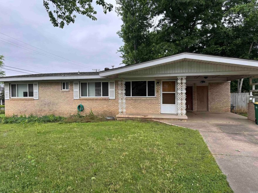 Perfect opportunity for Investor.  Great location for this 3 BR, 1.5 Bath all brick home.  Kitchen has gas stove and refrigerator.  French doors lead out to the covered patio overlooking the level, fenced yard.  Hardwoods can be refinished to look great.  Living room has large windows to let in natural light and it is open to the kitchen.  Laundry room can be accessed from the inside.  One car carport.  Corner lot.  Priced to Sell!!!  More pictures to be added.  Agents See Remarks!