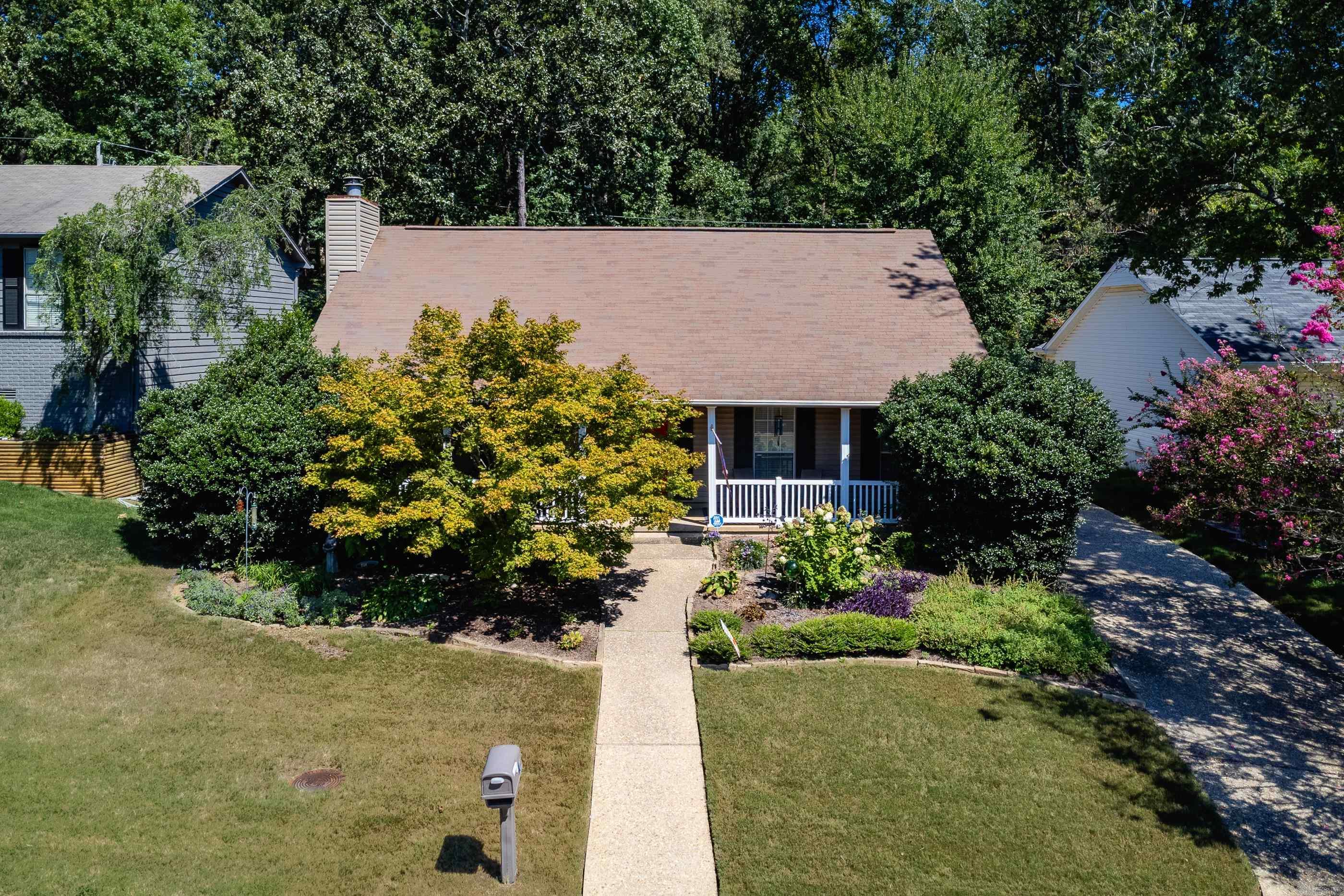Adorable one level home with large front porch. Inviting den has fireplace with gas logs, open kitchen and dining area. Kitchen has a flat top range and abundant cabinets. Primary bedroom with walk in closet and a luxurious updated bath, double sinks and walk in shower. Two additional guest bedrooms share hall bath completely updated with tub/shower. Walk out back yard with cozy deck. Two car garage has storm shelter and workshop bench. Come see!
