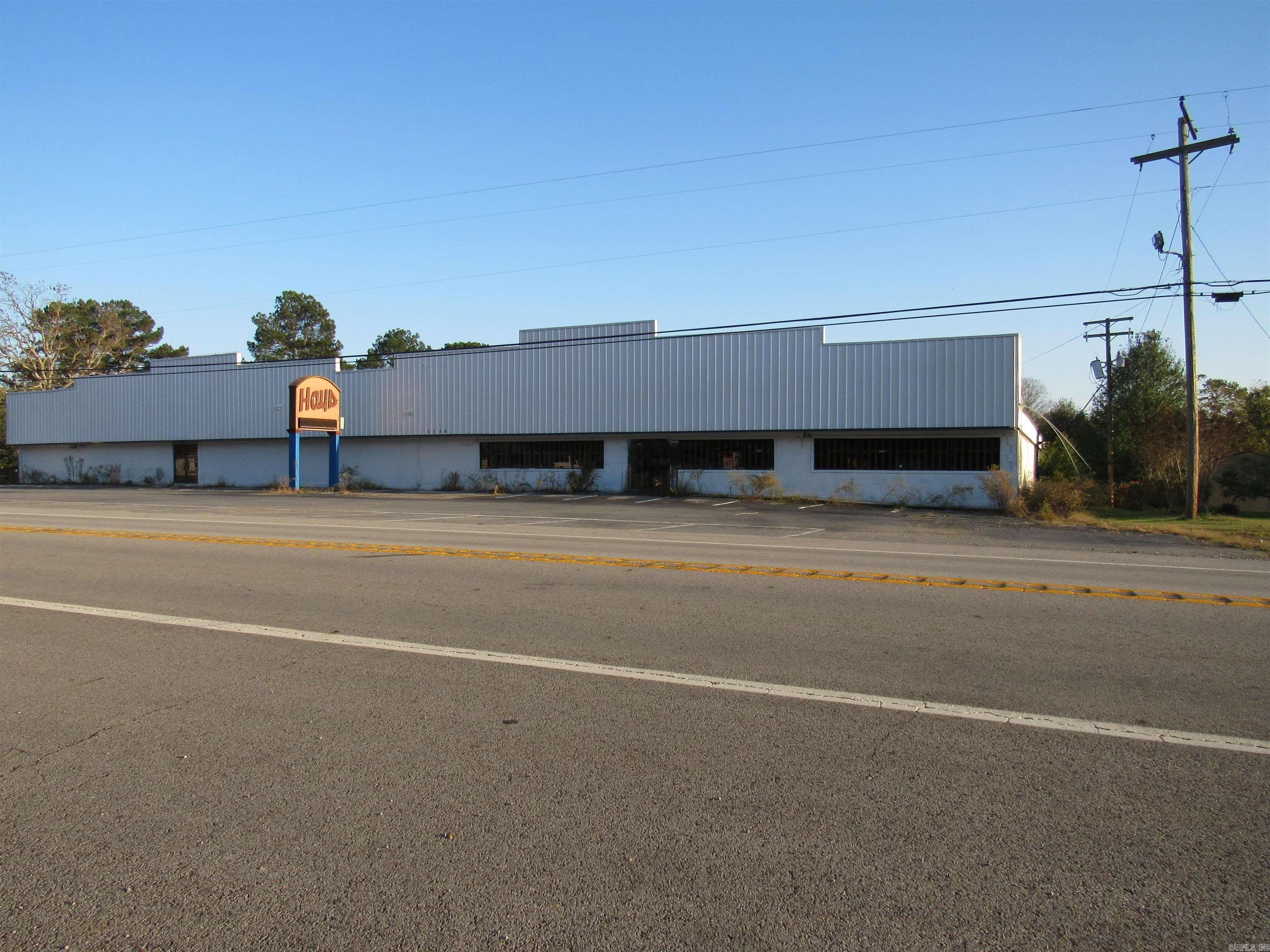 Expansive Commercial Opportunity: 23,000 SqFt Building on Nearly 2 Acres! Discover a versatile 23,000 square foot commercial prospect on nearly two acres. This expansive building, thoughtfully divided into 13,000 sq ft and 10,000 sq ft sections, offers flexible use and can be easily unified. The interior is designed for adaptability, featuring three well-appointed bathrooms, several private offices, and convenient dressing rooms. This adaptable layout is perfectly suited for a wide array of business ventures, including large-scale office environments, dynamic retail operations, a comprehensive fitness center, creative studios, collaborative co-working spaces, or even a light industrial facility. While needing revitalization due to past roof leaks (visible ceiling/wall damage), quotes for a new roof are available. The generous acreage provides ample parking and future development potential. This is a prime prospect for discerning investors or business visionaries. Sqft approx measuring encourage.