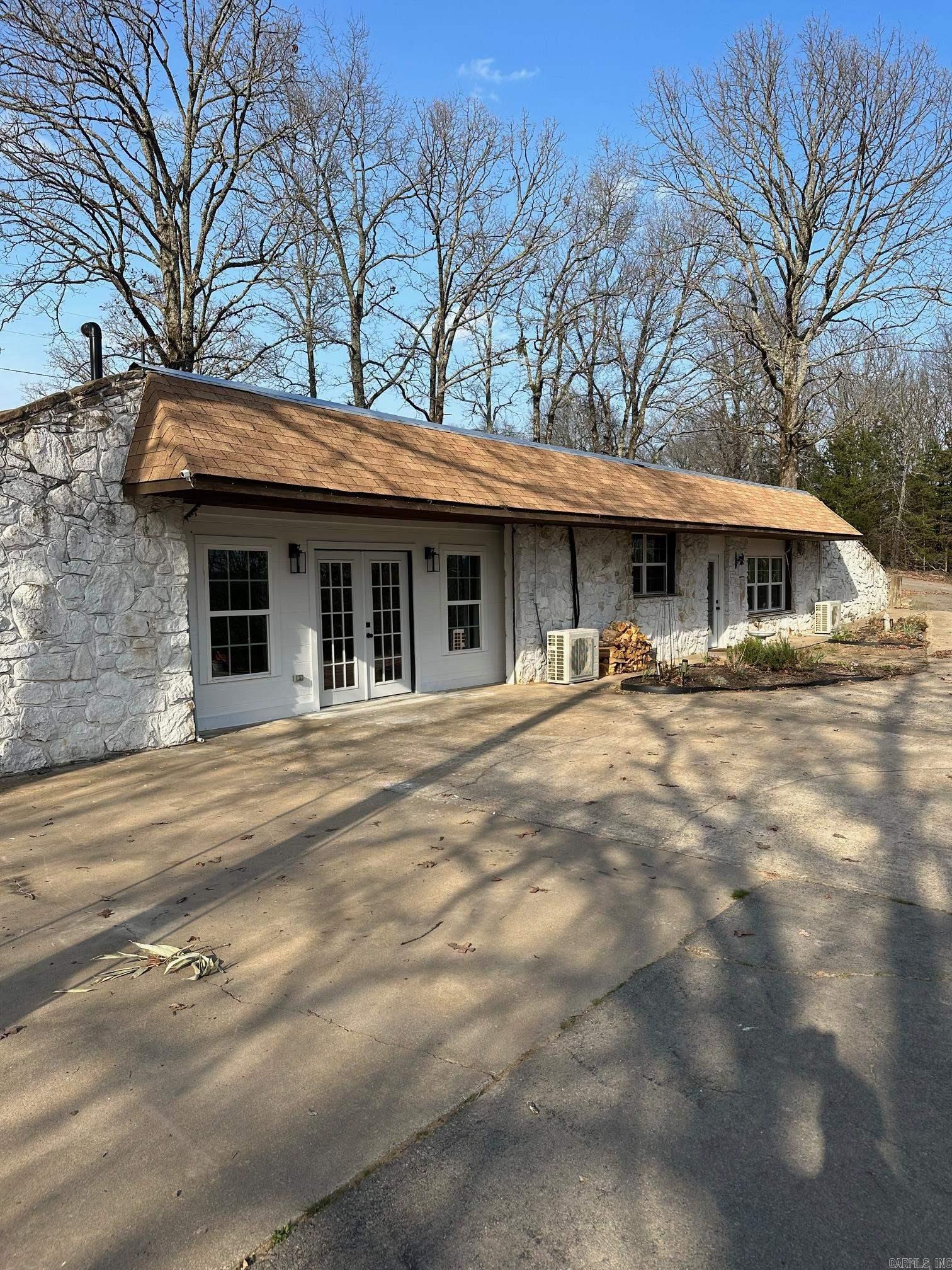 Come see Custom Built Underground Earth Home Sitting on 11 Acres. Enjoy the views from the Large Living Room window, overlooking the Valley below. 2 ponds located on the property. One is stocked with catfish. The home is a two bedroom one and a half bath. The exterior features a 20x30 livestock Barn, a 24x30 enclosed shop with electricity. Property if fenced for livestock