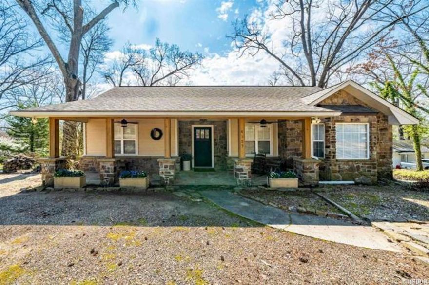 Discover Serenity and Scenic Beauty with This Stunning Lake Hamilton View Retreat! This exquisite 3-bedroom, 3-bath Craftsman-style home, crafted from Stone and Cedar, offers an unparalleled living experience. Ideally located near Oaklawn Racing & Casino, shopping centers, and medical facilities, this residence combines convenience with luxury. Meticulously renovated inside and out in 2018, this home seamlessly blends modern elegance with timeless charm. The main level features 2 spacious bedrooms and 2 well-appointed bathrooms, a breathtaking eat-in kitchen with panoramic lake views, and a cozy den with a fireplace, vaulted ceilings, and rustic wood beams. The lower level includes an additional bedroom and bath, a laundry room, a comfortable family room, and a wine closet. Step outside to the backyard where you’ll find a deck perfect for relaxing and taking in the serene vistas of Lake Hamilton, along with a well-maintained outbuilding for all your gardening needs. Embrace the perfect balance of luxury and practicality in this beautiful home!