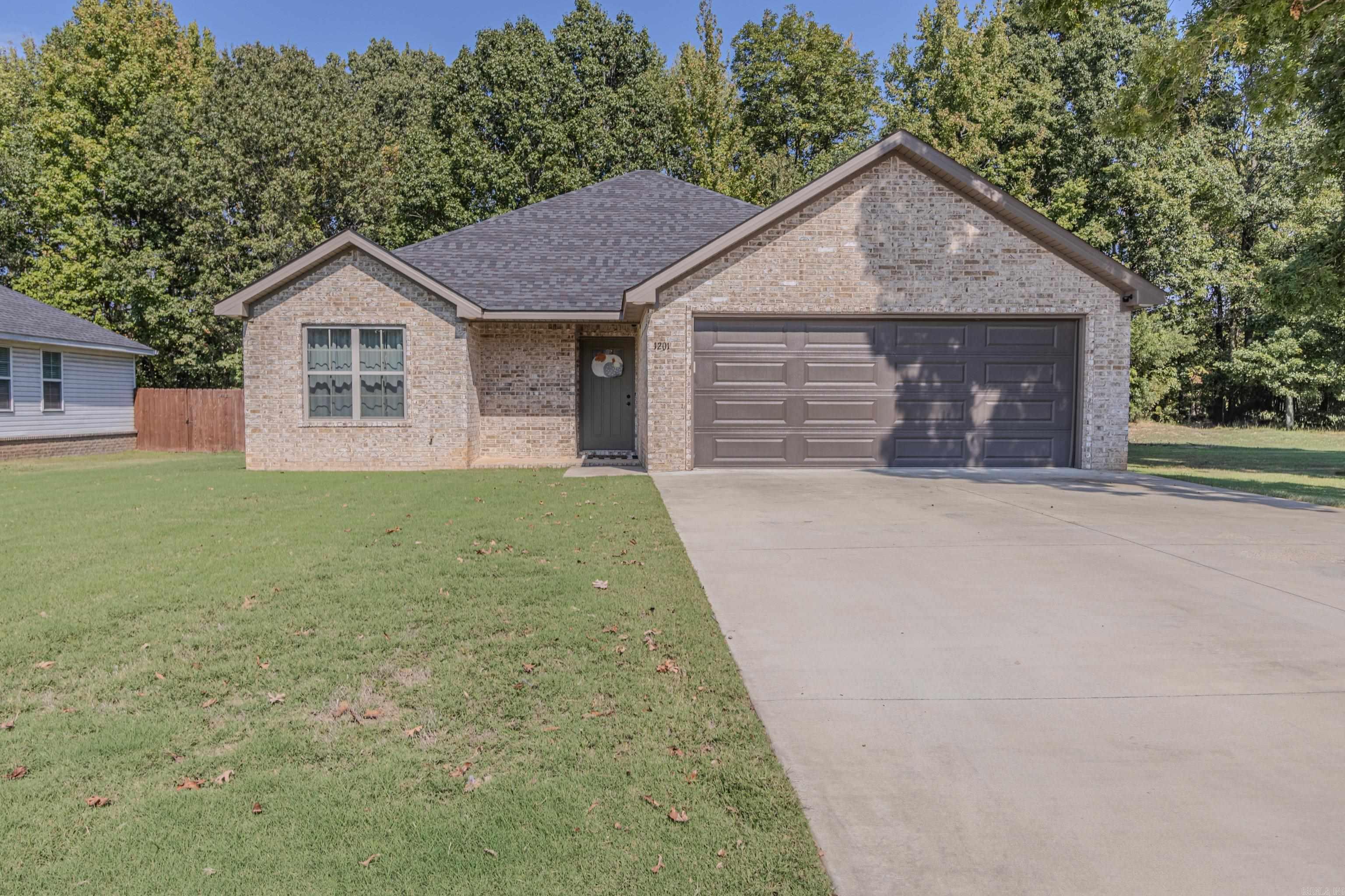 Built in 2022, this 3-bedroom, 2-bath home offers the perfect mix of modern style and comfortable living. The open-concept layout connects the great room, dining area, and kitchen for a bright, welcoming flow. The kitchen features crisp white cabinetry, stainless steel appliances, pendant lighting, a large island with seating, and a walk-in pantry for added storage. The split-bedroom design offers privacy for the spacious primary suite, complete with a tray ceiling, dual vanity, and a walk-in closet. You’ll also enjoy a formal dining area, roomy laundry space, and easy-care stained concrete floors throughout. Relax on the covered front or back porch overlooking the fully fenced backyard with plenty of space to entertain or play. With a 2-car garage, neutral finishes, and a move-in-ready feel—this home checks all the boxes!