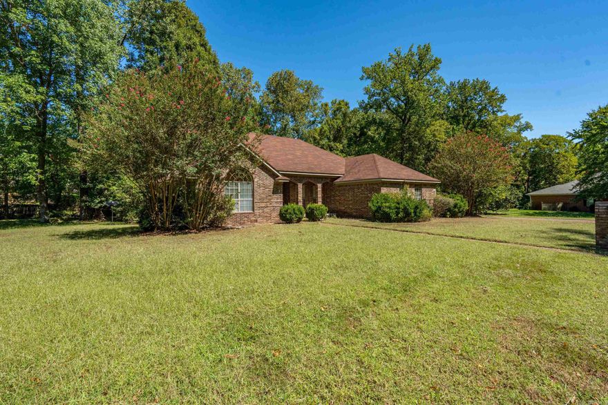 Set on nearly an acre in Arkadelphia, this home pairs classic style with everyday comfort. The welcoming brick exterior, wide front porch, and manicured landscaping create an inviting first impression that carries through the entire home. Inside, you’ll find 4 spacious bedrooms, 2.5 baths, and 1,967 square feet designed with tall ceilings, rich hardwood floors, and plenty of natural light.  This home was built for both relaxation and entertaining. The backyard retreat features an in-ground pool and a fully equipped outdoor kitchen, giving you the perfect setup for summertime gatherings or evenings under the stars. With .89 acres, there’s plenty of room to spread out.  From its timeless brick design to its modern amenities, this property delivers the best of both worlds—warm, welcoming interiors paired with a resort-style outdoor space.