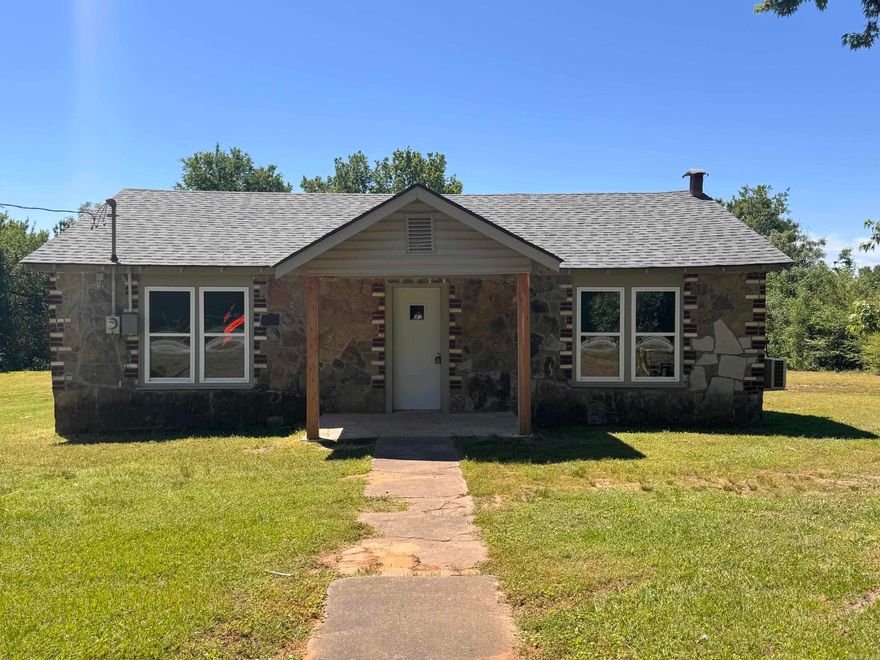 Charming Rock Home on 1 Acre!!  This rock home sits on approximately one acre and features new flooring, new bathtub and sink vanity, fresh paint and conveniently located close to either Westside or Clarksville School District.   The property includes extra outdoor storage, providing useful space for tools, equipment, or additional belongings. The acre of land gives you room to spread out, expand, or simply enjoy extra privacy.  The perfect starter home or investment property to personalize and make your own! Call today for your Showing!