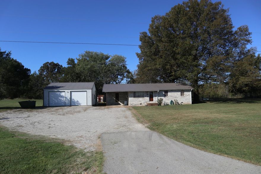 COUNTRY HOME & SHOP WITH ACREAGE ON US HWY FOR SALE SALEM AR  Property located at 2577 Hwy 62/412 E, Salem, AR. This 3 bedroom 1 bath home has approx. 1233 sq. ft. of living area. 1 car carport.  It has window AC and gas heater, dishwasher and gas range. Also includes laminate and vinyl flooring. Private well and septic system. Rural water is also available. Also includes a 30 x 30 metal shop building with a 10 x 30 lean to shed on the back. The shop is insulated and has concrete floor, electric, mini split heat & air unit and gas heater. Great place for your work space and hobbies. Also includes a 2 car parking shed. Chain link fenced back yard with several large shade trees. Plenty of space for your garden. Newer metal roof on the house and shop. Great location just a few minutes from Salem. Lake Norfork, Spring River and the world famous White River are within 30-45 minutes. Taxes last year were $601.50. Make your move to the Ozarks.