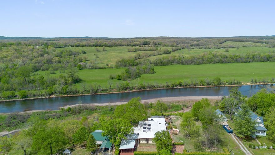 Stunning Mid-Century Modern Pueblo Home with White River Frontage. Located in Cotter Arkansas. The Trout Capital of America! This captivating 4-bedroom, 3-bath residence sits on 5.0 ac/ml of picturesque White River frontage, offering a serene escape with breathtaking panoramic views. Dive into luxury with a 15x30 indoor swimming pool, perfect for year-round enjoyment. The chef's kitchen, complete with a butler's pantry, is designed for culinary enthusiasts, while the living room boasts skylights that flood the space with natural light. The thoughtfully designed primary bedroom and bath provide a tranquil oasis for relaxation. Discover the charming attached guest cottage, ideal for visitors, and enjoy multiple levels of outdoor decking, perfect for entertaining or soaking in the stunning White River scenery. This home seamlessly blends modern comfort with a touch of mid-century charm, all in a sought-after location. Don't miss the opportunity to own this extraordinary landmark property.