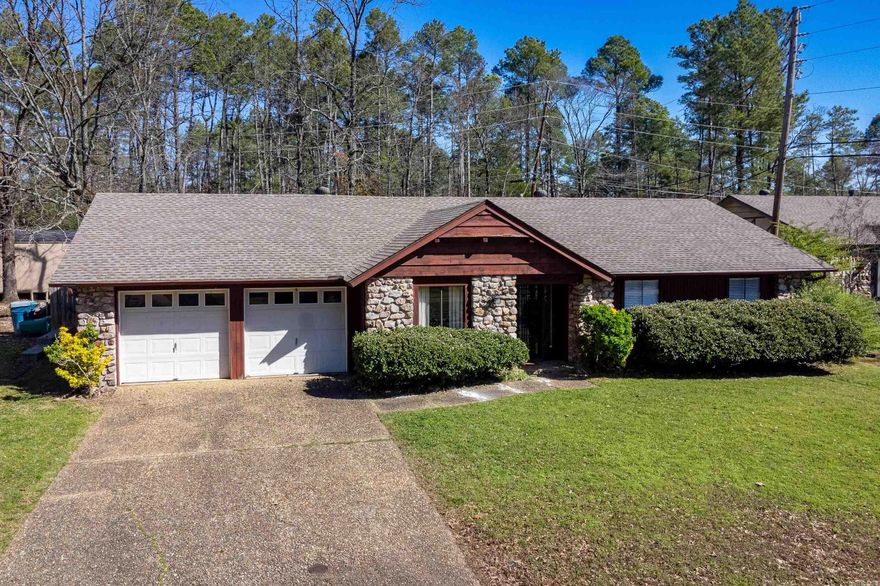 Sweet one level on nice sized level lot backing to green space and walking distance to Foreman Lake. Formal living and dining space off front foyer. Spacious vaulted Den/family room with stone fireplace and beamed ceiling. Primary bedroom has walk in closet and updated tile shower in the ensuite bath. Two nice sized guest bedrooms and hall bath as well. Charming galley kitchen with space for informal dining. Sliding glass doors open to large backyard with patio, gazebo covered grilling area, lush landscaping and mature trees. Two car garage with laundry area. Come See!