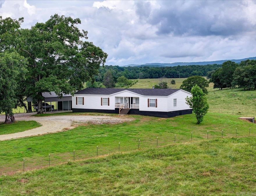 Completely remodeled 3 bed 2 bath manufactured home sitting on a permanent foundation with approximately 1.7 acres in Lake Hamilton School District.  No neighbors, this property overlooks hundreds of acres of beautiful pastureland. Million dollar views all around and the sunsets from the covered back porch are absolutely beautiful. Only 2 mins from Brady Mountain rd, which makes extremely convenient access to Lake Ouachita. New architectural shingled roof and vinyl siding installed in 2024. Luxury vinyl plank flooring through house, butcher block countertops in the kitchen. The oversized master suite features a clawfoot bathtub and huge walk-through closet. Outside there is a nice shop, carport, storage building, and storm cellar.
