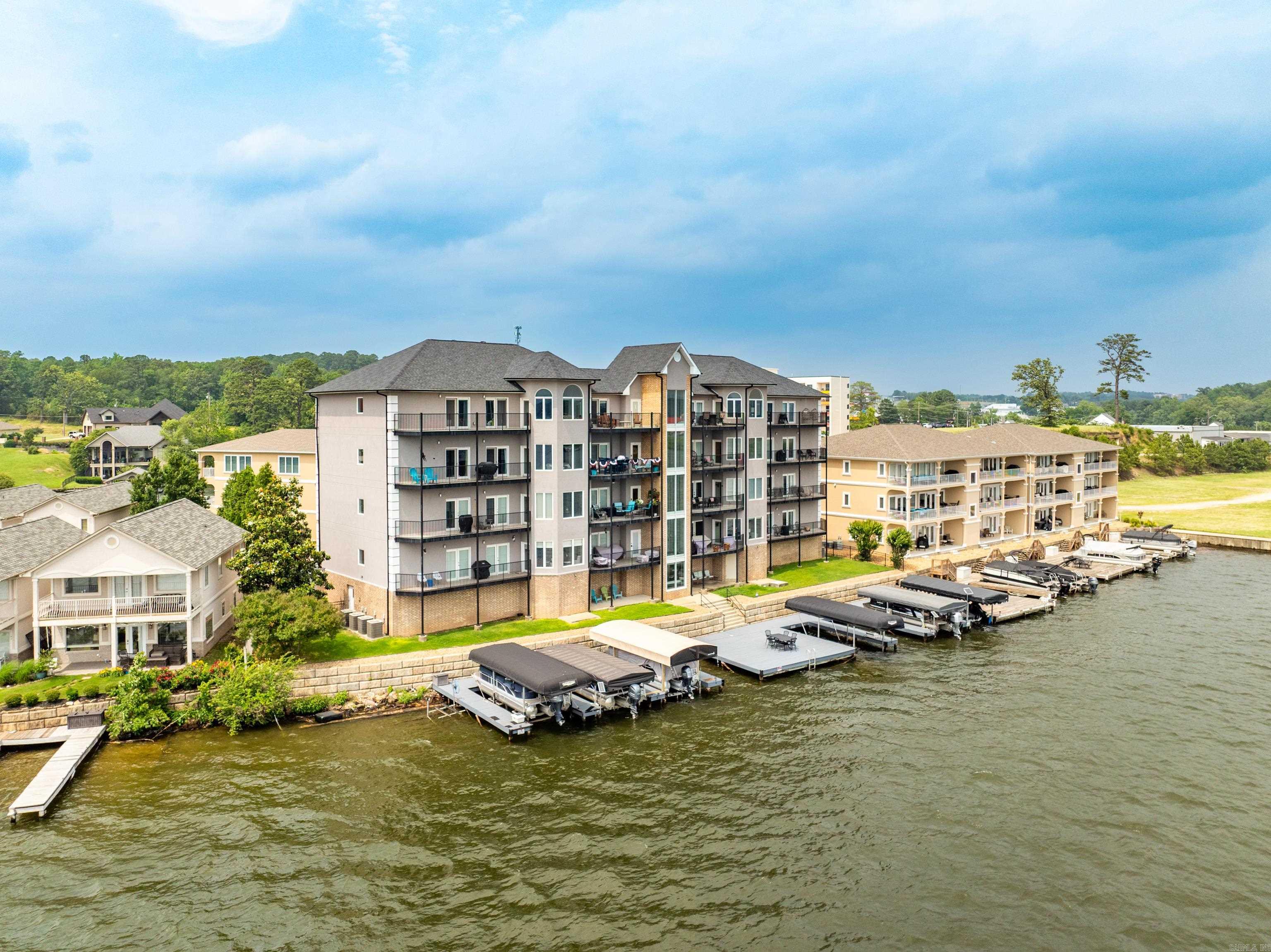 This AMAZING Birdās Eye View Condo Overlooking Lake Hamilton is in the Most Perfect Location!The moment you walk thru the door you're greeted w/stunning panoramic lake viewsThis beautifully updated,fully furnished condo offers an open floor plan w/tile flooring,custom trim & thoughtful designer touches throughout.Enjoy a spacious kitchen w/a large breakfast island,new quartz countertops & backsplash,ss appl,updated hardware & lighting.A cozy living area flows onto 2 private covered balconies-ideal for watching sunsets or fireworks right over the water!The master suite features dble doors to the balcony,lake views,walk-in closet w/built-ins & a luxurious ensuite bath complete w/a newly tiled walk-in shower,whirlpool tub & dble vanity.2 additional lakeview bedrooms also have balcony access & walk-in closets.A bonus room serves as a 4th bedroom/office.The Wet bar has a new quartz countertop & backsplash & wine rack.Enjoy your own Private boat slip w/lift,the shared deck & swim launch or the inground pool & pool house.Also included is a High-speed elevator w/access from the code-entry ground floor,covered parking & a storage room.Donāt miss your chance to own the best seat on the lake