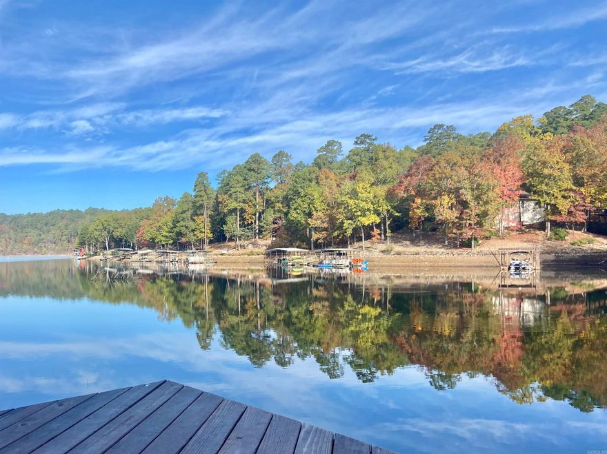 Stunning Lake Cortez Waterfront Retreat! Discover this fully renovated 4BR/3BA Lakefront home on a low-maintenance 0.68-acre lot. A south exposure ensures bright interiors and refreshing lake breezes without the intense afternoon heat. Concrete paths lead from the home directly to your private dock, fire pit and picnic areas. The main level features panoramic lake views from the living and dining areas, the primary suite and ensuite bath, the large Arkansas room, and expansive deck. Enjoy a modern kitchen with new appliances, dinette, a large office/flex room, a second king-size bedroom and full bath —perfect for easy one-level living. The lower level is built for entertaining, offering a second living area, game room, flex room, a second expansive deck, two additional bedrooms, and a 3rd full bath. With electric fireplaces and durable easy to clean waterproof vinyl flooring throughout, this large home is both cozy and practical. Currently a high-performing, fully furnished vacation rental (some exclusions apply), it’s a turnkey opportunity for personal use or continued income.