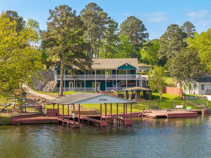 wo homes in one, endless possibilities, and a front-row seat to the beauty of Lake Hamilton—this exceptional waterfront property in the sought-after Tanglewood Subdivision offers a rare blend of luxury, flexibility, and income potential. Designed with versatility in mind, this custom-built residence spans two fully equipped levels that can function seamlessly as a single expansive home or as two independent living spaces. The upper level (2,770 sqft) and lower level (2,310 sqft) each feature a full kitchen, private entrance, laundry facilities, and generous living and dining areas—ideal for multi-generational living, hosting guests, or generating rental income while occupying the main floor. Step inside and you’re immediately drawn to the wall of windows and glass doors framing tranquil lake views. The main level boasts a luxurious primary suite complete with an extraordinary walk-in closet, while a dedicated office offers an inspiring work space overlooking the water. Thoughtful details continue throughout, including soaking tubs, custom walk-in showers, and a cozy wood-burning fireplace that anchors the living space. Outdoor living is just as impressive.