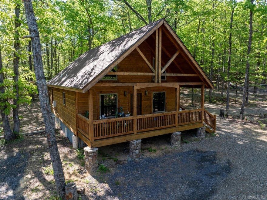 Looking for an INCREDIBLE investment opportunity with guaranteed income? Take a look at this TURN-KEY, SUCCESSFUL Vacation Cabin business just minutes from Wolf Pen Gap Trail System! Sitting on 16 acres, and backed by national forest, the property features 5 cabins, a large stocked pond & a stunning waterfall!  Masterfully constructed & thoughtfully decorated, each NEW cabin boasts rustic cedar exterior, white Blue Spruce Pine interior walls, luxury vinyl flooring, full kitchen with new appliances, a spacious loft, an electric fireplace, mini splits, attractive furnishings, private back patio, & fire pits! Three cabins have hot tubs, perfect to enjoy after a day on the trails! The newest cabin is the ideal layout and location for groups, it includes 2 bedrooms w/ queen beds, a loft with an additional queen bed, a large open concept kitchen and living space, and a washer/dryer. Next door there is an RV hookup with a BRAND RV ready to rent. Property currently has an ATV rental business which adds yet another level of value to this PRIME property. This property is absolutely STUNNING with so much value and potential! Don’t miss your opportunity to capitalize on Mena’s ATV tourism!