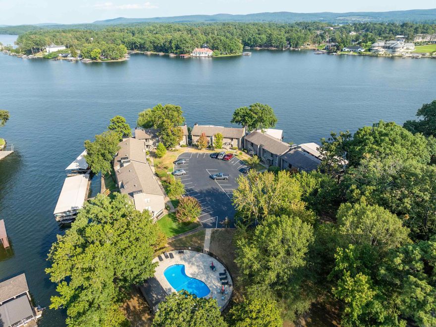 This stunning 2 bedroom, 2 bathroom condo at The Moorings complex offers the epitome of lakefront living on Lake Hamilton, and is being sold furnished. Situated in the coveted 7 South area, the prime location is highly sought-after. As you enter the condo, you're immediately struck by the gorgeous views of the lake through the abundance of natural light pouring in. The living area boasts a cozy wood-burning fireplace, perfect for cool evenings. The spacious primary bedroom is a true retreat with a luxurious en-suite bathroom and walk-in closet. Step out onto the covered patio and take in the breathtaking lake vistas while enjoying your morning coffee or evening cocktails. This unit is a true gem, offering a rare opportunity to own one of the best units in the highly coveted Moorings complex. Adding to the allure, the condo comes with a covered boat slip, allowing you to seamlessly transition from your waterfront oasis to the serene waters of Lake Hamilton. Don't miss your chance to make this slice of paradise your own.