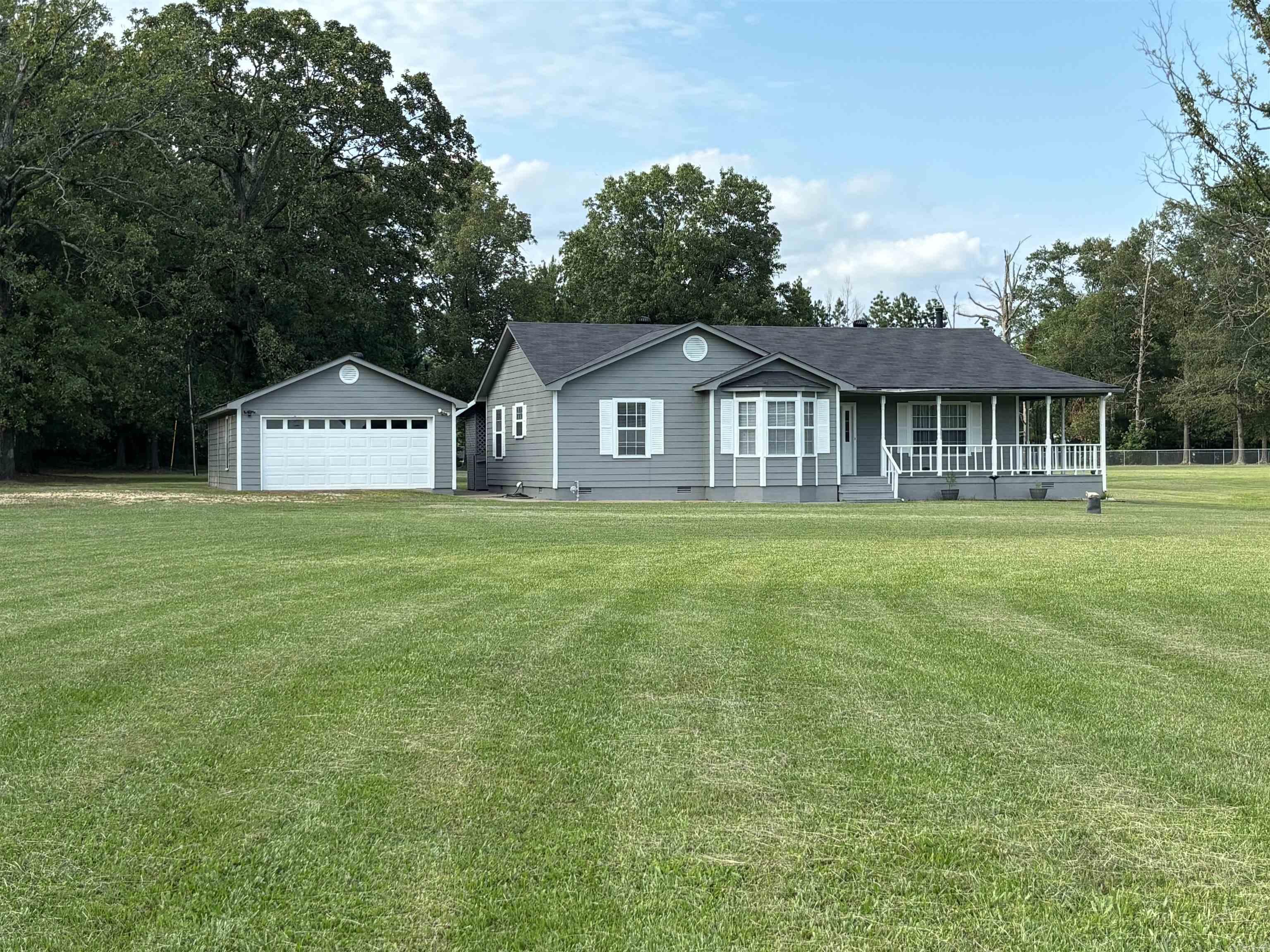 This one will sell fast*3.59 acres with 3 bedrooms and 2 baths*in 2023 sellers put on new roof, all new flooring (luxury vinyl), fresh paint on exterior and interior, remolded master bath and replaced gas water heater*dishwasher new in 2024*the master suite has a walk-in shower with safety features and a huge walk-in closet*wrap around porch with huge deck on back*detached 2 car garage with shop in back that has an above ground storm cellar*land is gorgeous*wired for generator*bring you kids and animals* The septic system is in the front yard and the field lines are on adjoining property owner, I put the septic information that I was sent from the Health Department under the MLS docs*hot tub does not work but sellers purchased a part that they think will fix it that they will leave*selling hot tub as is*