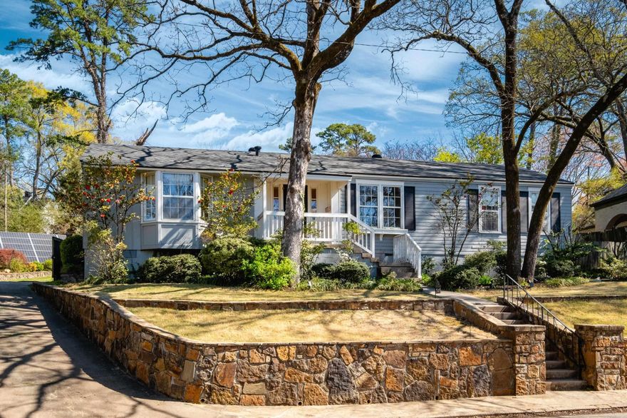 This cute Hillcrest Bungalow has an amazing oversized lot with approx 1/3 of an acre. Stonework lines the front and driveway.  The living room features built-in cabinetry and window seats and opens to the dining room. The spacious kitchen includes a pantry and is open to a fantastic breakfast area with a fireplace and an adjacent 2nd living area with built-in shelving. The screened porch off the kitchen is the perfect spot to relax and enjoy a beverage outdoors. It leads to a flagstone patio, shaded in the afternoon and perfect for entertaining. You will love the incredible backyard - it is huge! fully fenced, and has a great feeling of privacy. BONUS the solar panels are completely paid and have a battery backup = no loss of power! and an EV charger. New roof in 2023, heat pump 2019. Walk to schools, parks, medical, shopping, dining.