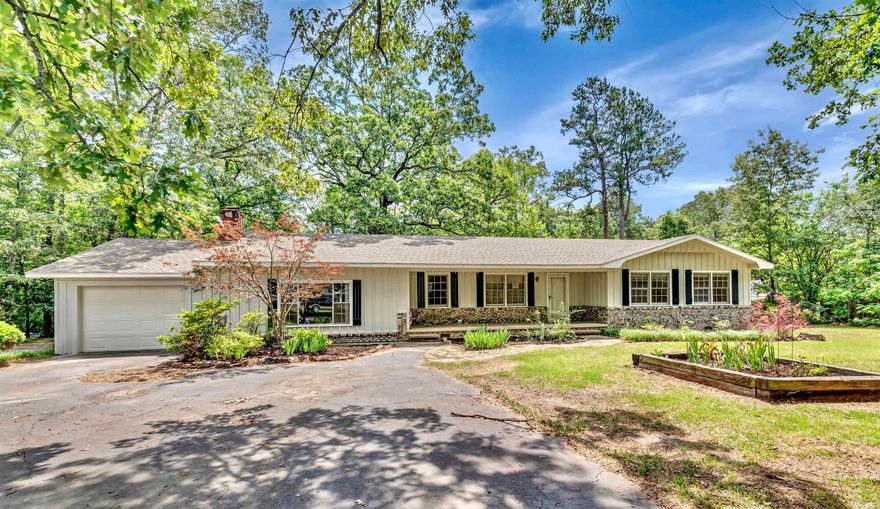 Introducing this expansive 3,176 sq. ft. 6-bedroom, 3-bathroom brick home, sitting on a generously sized .87 acre lot with mature trees and all kinds of plants. With ample space for everyone , this home offers exceptional storage and functionality. The inviting large den features a cozy fireplace, ideal for relaxing evenings. The luxurious main suite includes a spacious sitting area and a large bathroom complete with a Jacuzzi tub and a walk-in shower and a nice size walk in closet. For added convenience, the home features a one-car garage, additional parking spaces, and a charming circle drive. Recent updates include a fresh coat of exterior paint and the professional installation of two new central heating and air units, ensuring year-round comfort and new professionally installed gutters. Located on a peaceful street, the property is just minutes from downtown Mena, offering easy access to shopping, dining, and the natural beauty of the surrounding Ouachita mountains and close to national forests. Enjoy outdoor living with a large back deck, perfect for entertaining or unwinding. This home truly offers space, comfort, and convenience. Agent owned.