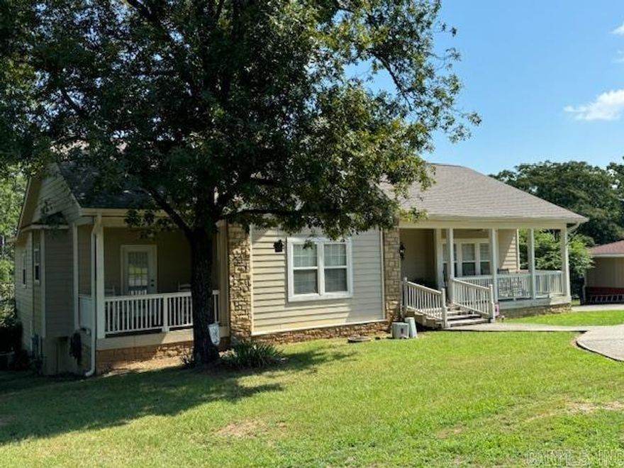 Very unique opportunity to own a spacious 5 bedroom, 3 bath home located on one acre, 1 block from Lake Hamilton.  The fabulous floor plan creates the ultimate setting for family living and entertaining with a large open kitchen, eat-in bar, and dining area which flows into the den.  The den has a fireplace, vaulted ceilings, and opens to a large deck. The 5th bedrooom located on the ground level can be used as an apartment, mancave or mother-in-law's quarters. The double garage has additional storage.  New hotwater heater and roof in 2023.   Square footage has been updated and increased based on recent appraisal.   A repair allowance for Patio and privacy fence with an acceptable offer.
