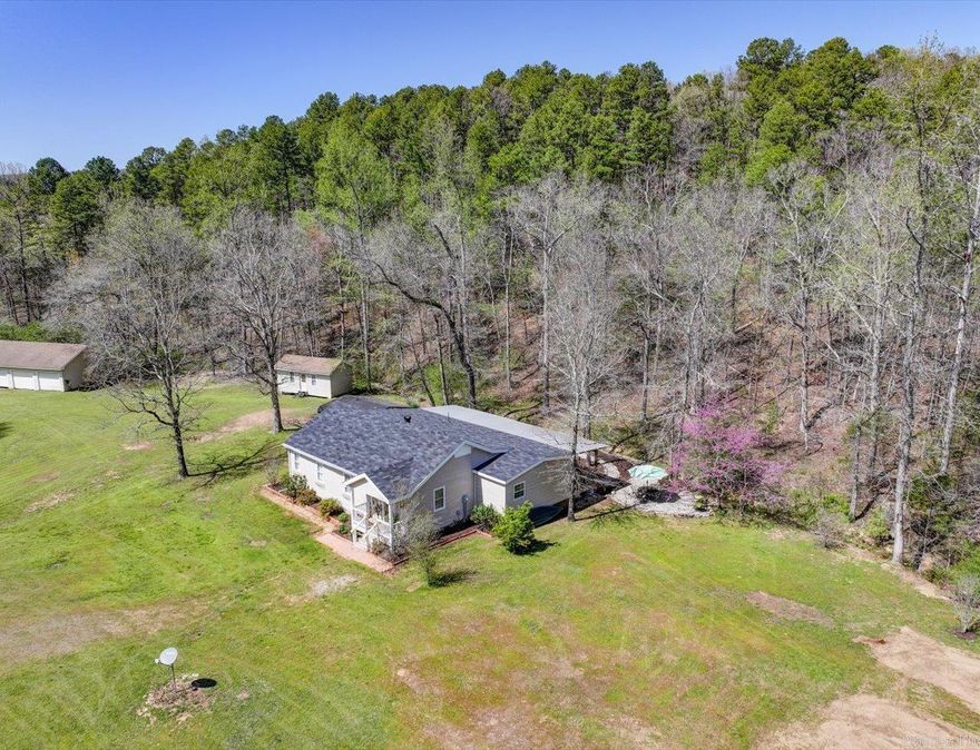Escape to the tranquility and beauty of the Ouachitas with this charming 3 bed, 3 bath, ranch-style home on 5.78 acres, approx. 4 miles from Brady Mountain Marina and Lake Ouachita. Bordering national forest land, this recently updated home features a 2024 remodeled kitchen w/Quartzite countertops, spacious living areas, and a large covered rear porch with ceiling fans for relaxing in the shade. Outdoors, enjoy a 4-stall garage/workshop, 8'x12' workshop, covered RV and 2 car carport, garden shed & fenced garden spot, and a private well for irrigation and gardening. Freshly painted. New roof, water heater, disposal and ceiling fans in 2024.  New HVAC 2025. Whether you're looking for a serene full-time residence or a weekend getaway, this property offers space, privacy, and incredible access to outdoor adventure.