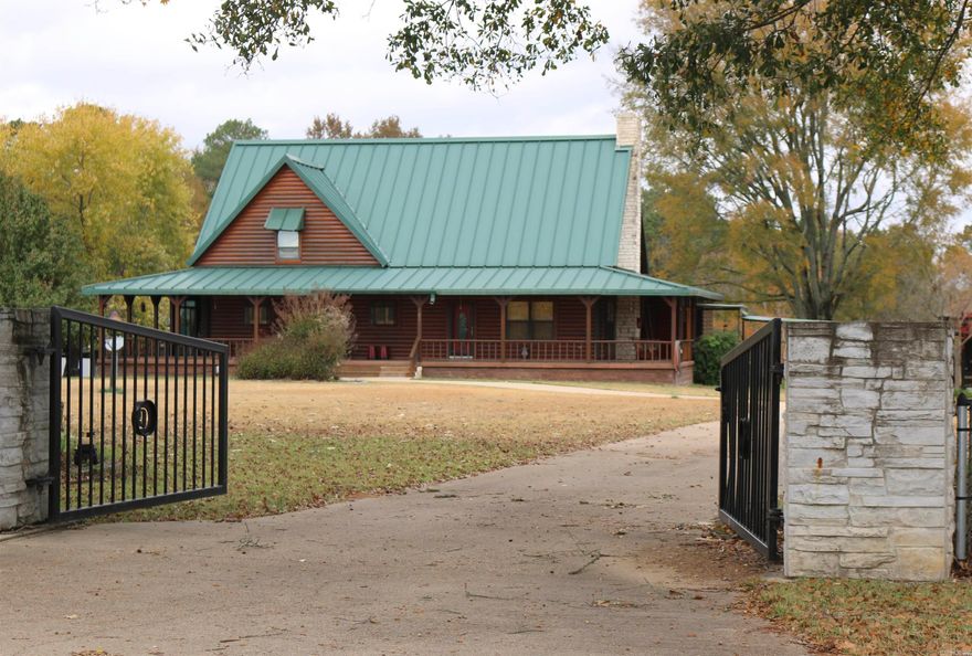 This stunning 3 bedroom, 3 bath log home sits on 10 private acres in the beautiful countryside, conveniently located just 11 miles from Nashville, and 9 miles from Blevins.  The property features a concrete circle drive, 2 car garage with lots of room for storage, an approx. 3600 sq. ft. barn/shop, a gazebo with outdoor kitchen, a greenhouse and so much more.  The spacious open concept living/dining area of the home is warm and inviting with a large primary suite and balcony area upstairs.  The primary suite has a sitting area, 3 large closets and a bathroom featuring a whirlpool jetted tub.  The barn/shop is an added bonus that provides a huge additional space with endless possibilities.  Once you come and sit on the porch you will not want to leave! Property being sold "as is".