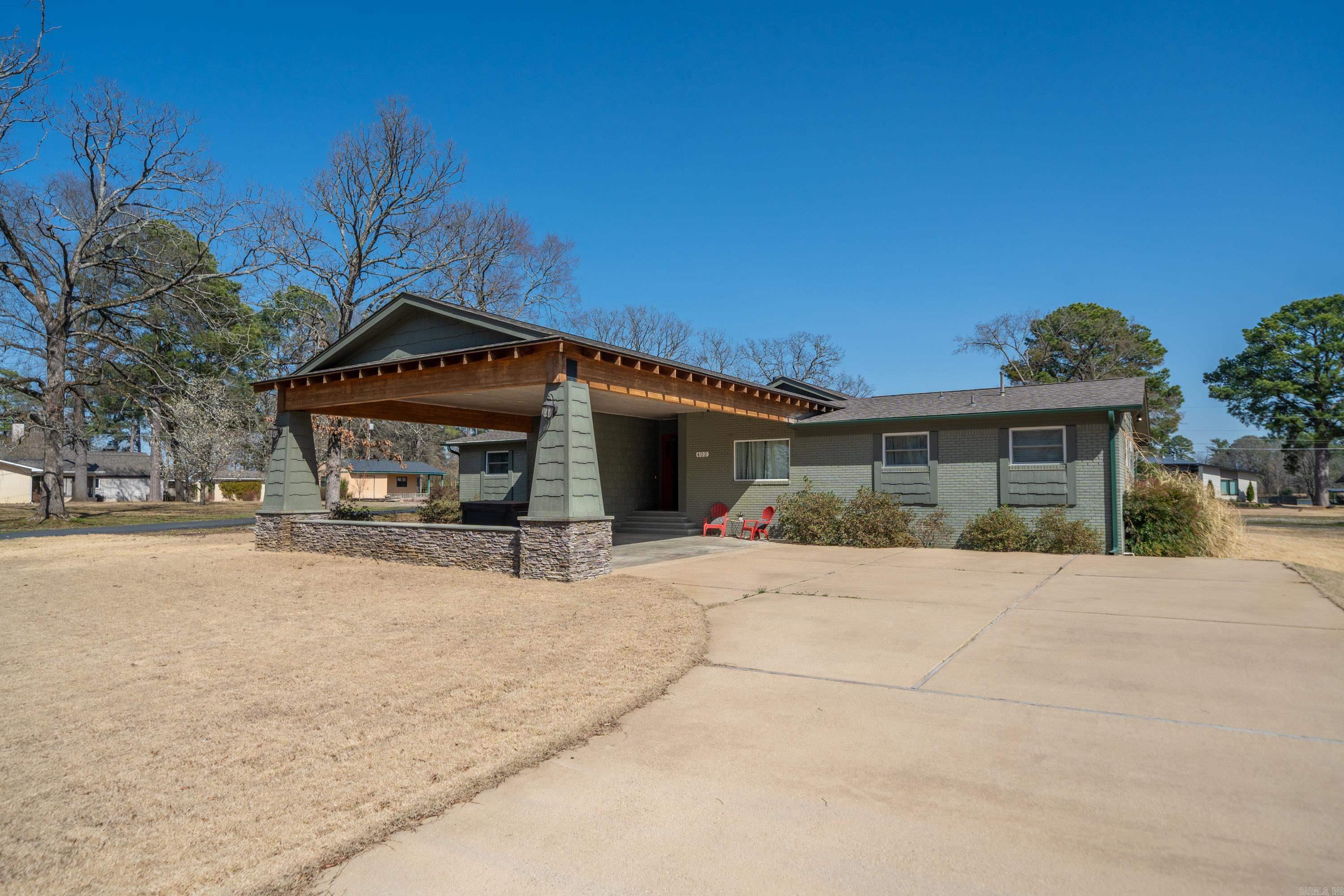 BOAT DOCK!!!! This Beautifully Updated Home Sits Across The Street From Lake Hamilton And Includes A Boat Dock! This 3 Bedroom 3 Bath home is in the highly sought after 7 South area in Caroline Acres. This home has been updated throughout with custom cabinetry and granite countertops in the kitchen and bathrooms. There is a fabulous glass enclosed family room with a fire place and vaulted ceilings. The kitchen features banquet seating and counter seating as well. There is a separate laundry room and an office with a built in desk. There are great views of the lake from the front and back of this home. Take a look at this one today!