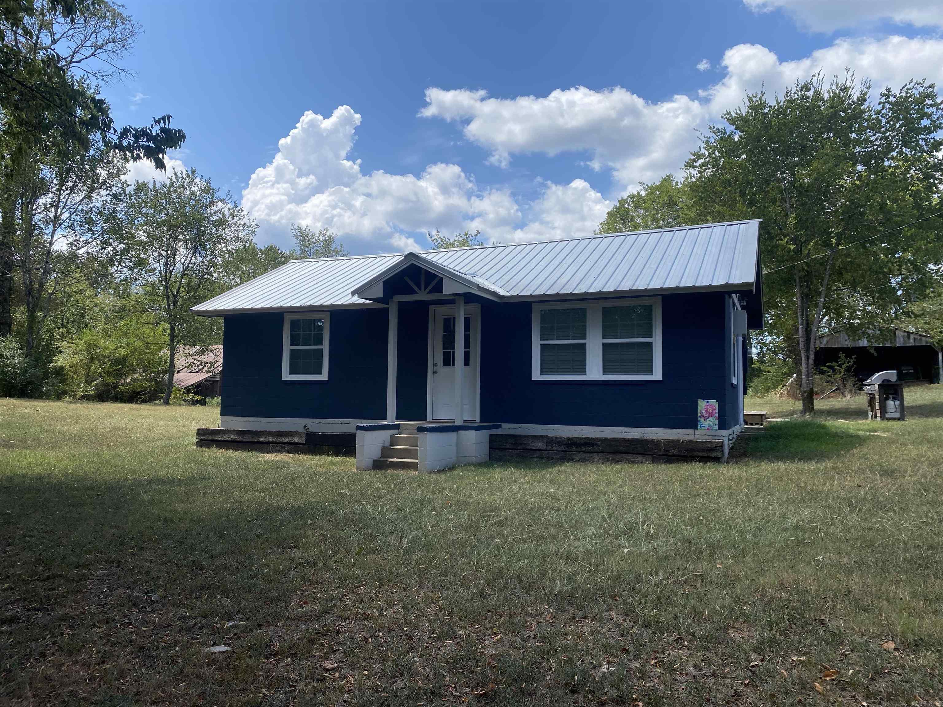 Two for the price of one! Located in the Washita Community right near Lake Ouachita and Deer Creek, which flows into the Lake, this 3 acre more or less property has two houses! The smaller unit is move in ready with 1 bedroom, 1 bath which was recently updated. It makes the perfect weekender or just a great space to stay will finishing the rehab job on the larger farmhouse. In the farmhouse there are original hardwood floors in part of the house, wood burning fireplace, 2 year old roof, new siding, and tons of space all in this 1828 square foot. And the yard is a gardener's dream. Tons of space to grow a vegetable garden, outside storage building and small barn, fruit cellar are all inside the fenced yard. Call today to setup your tour! $219,000.00