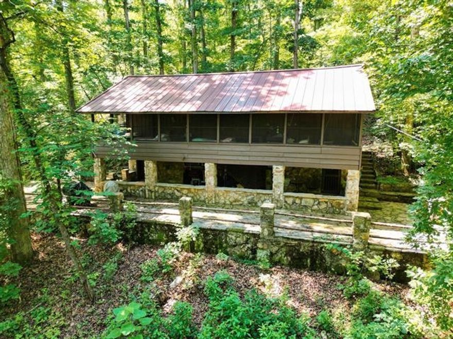 Unique 1937 cabin located in the Ozark Mountains on Historic Wahpeton Hill high above and just a short distance to Spring River, Loberg park, the river trails, the Hardy beach river access for swimming, kayaking, floating, world class fishing and downtown Old Hardy! 2 bed, 1.5 bath on 4.34 surveyed acres+/- in the depth of the woods yet minutes away from town amenities. Beautiful rock work all around the home, sit and relax outside while enjoying the fruits of nature. Main level includes living area, 2 bedrooms, large screened in porch, and a warming fireplace. Downstairs includes kitchen, full bath and half bath. Check out the history of this one of a kind property. Includes new roof 2022, new windows 2024, new insulation 2024.