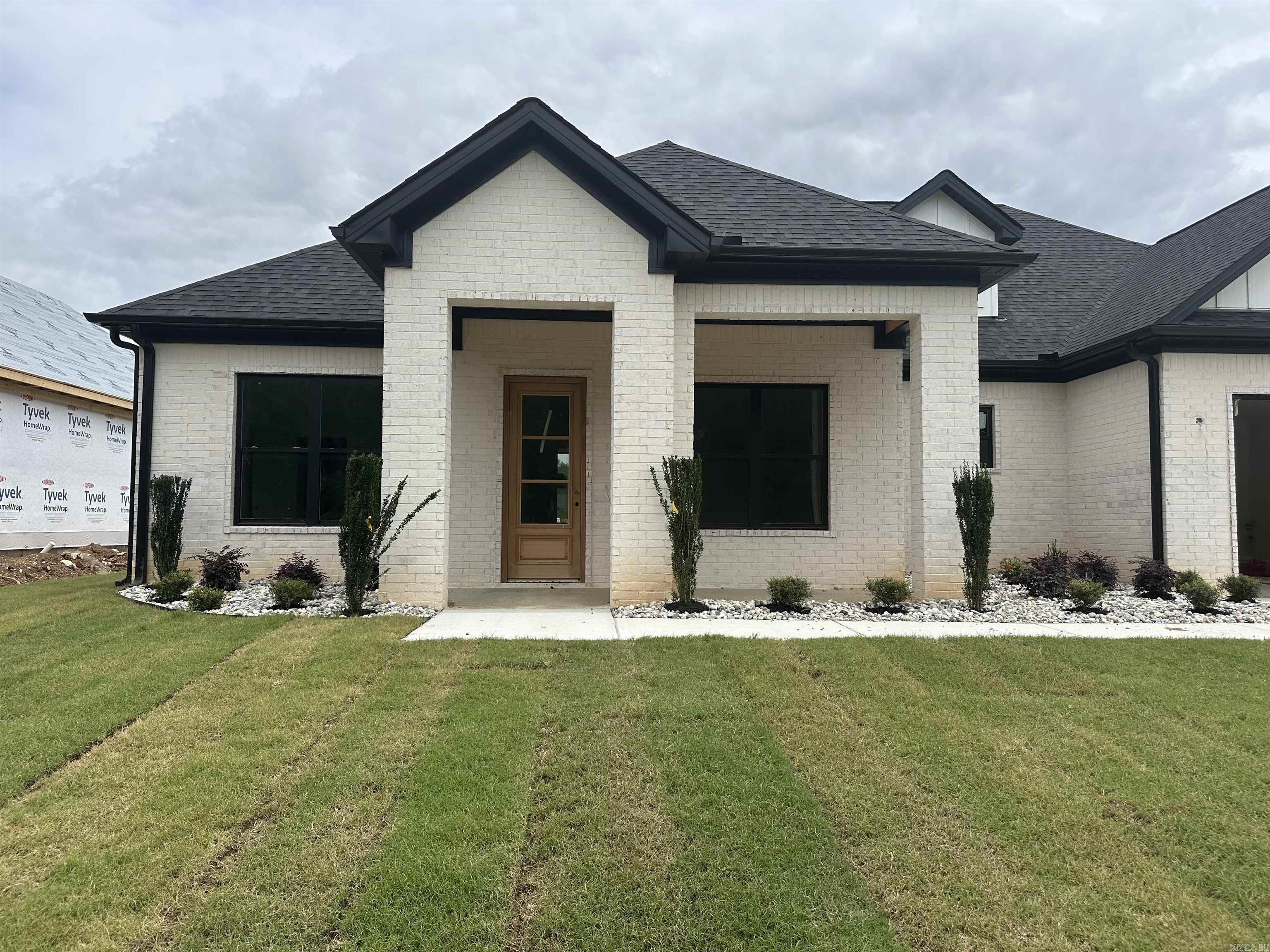 Discover modern living in this nearly completed new construction home! Featuring 3 bedrooms, 2.5 baths, and an inviting open-concept design, this residence is brimming with upscale details. From the light and natural color scheme to the warmth of the wood accents- this home is ready for your personal touches. Enjoy cooking in a gourmet kitchen equipped with quartz countertops, a walk-in pantry, and all-natural gas appliances. The office off the entry adds function, while LED lighting enhances every space. Retreat to the primary suite with a pass-through laundry to the master closet, split vanity with ample storage, a luxurious free-standing tub, and a walk-in shower. Located in a vibrant neighborhood close to everything and within Bryant Schools, you’ll also enjoy access to amenities like a pool, splash pad, tennis and pickleball courts, lake access, and year-round community events. Schedule your private tour today and make this your dream home!