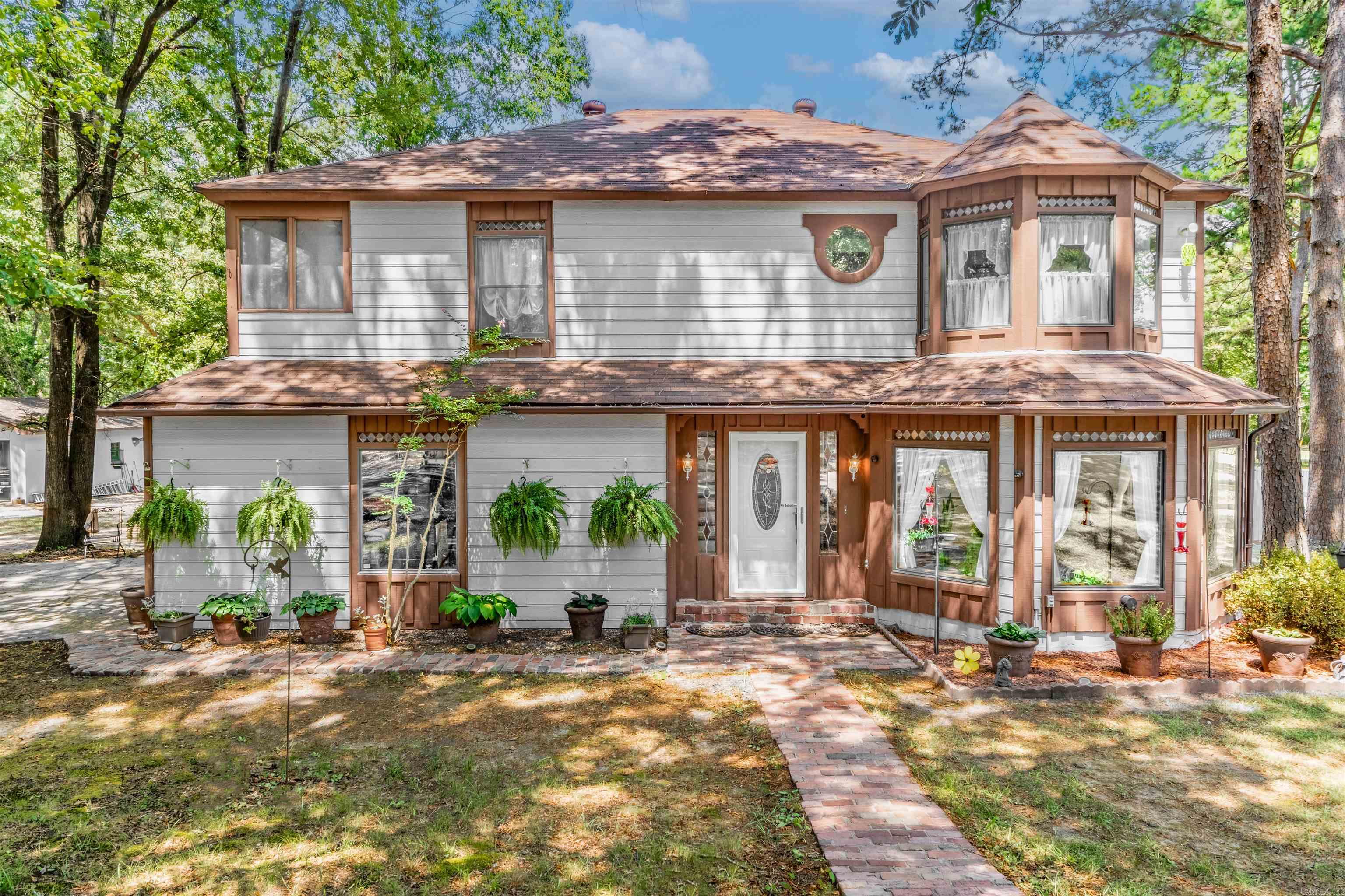 This enchanting Queen Anneāstyle home sits on 4.91 acres framed by mature trees. The grounds include a year-round pond, fenced pasture with barbless wire and wood fencing, and garden space with rich soil and raised bedsāperfect for horses, gardening, and small-scale farming. The spacious 2,663 sq ft layout features 8-foot ceilings, generous storage throughout, and insulated Pella windows that fill the home with natural light. Recent updates include a new roof, quartz kitchen countertops, granite in the primary bath, new carpet, new LVT and tile flooring, and an updated walk-in shower. Additional features include an attached two-car garage, a detached 24x30 garage/shop, and a beautiful in-ground pool (new liner, pump, & filter 2023). The home also offers a large screened-in porch and a screened walk-out balcony off the bedroom. Located in the Conway School District, this property offers a peaceful setting with space to enjoy both home and land.