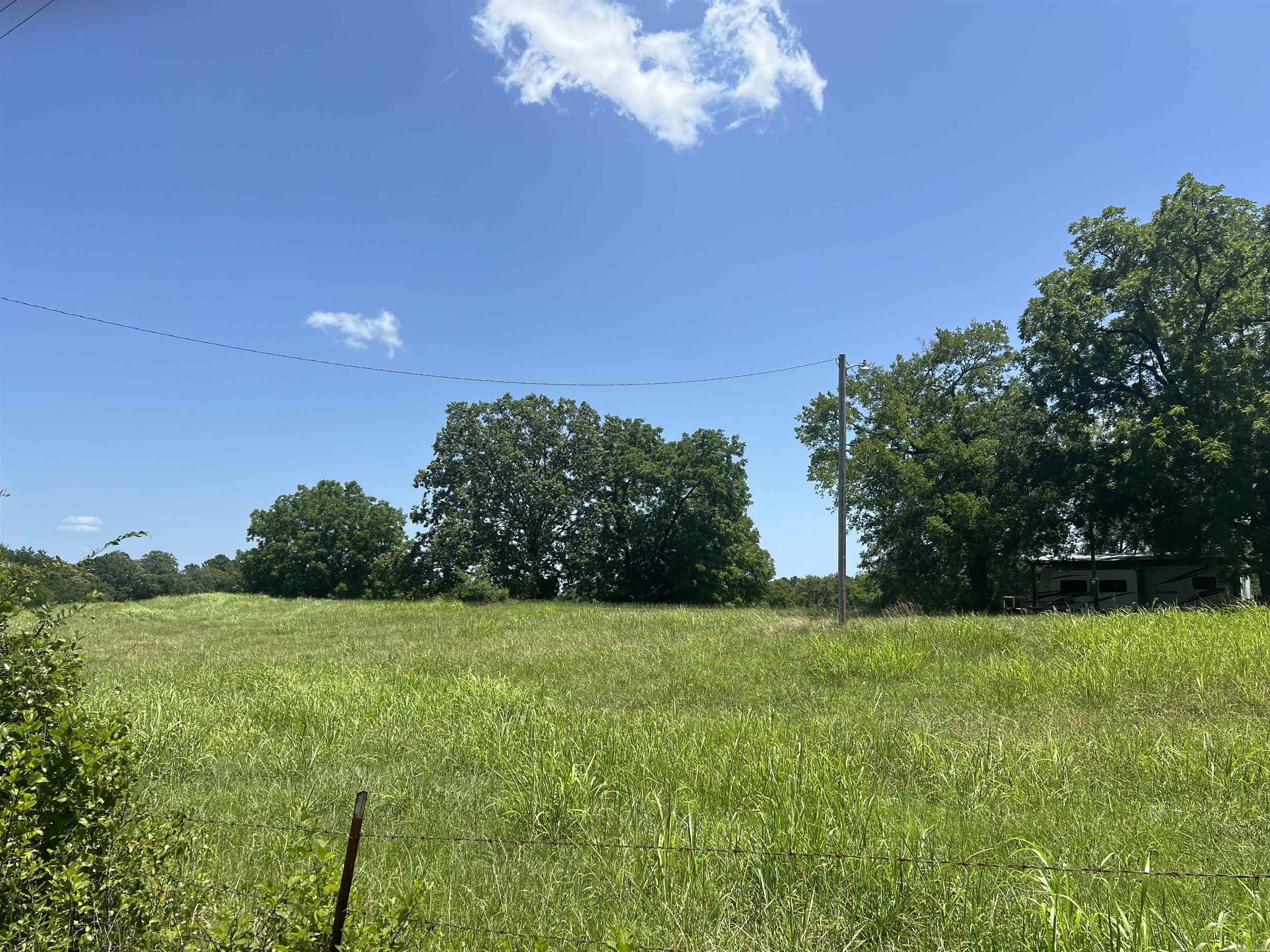 RARE OPPORTUNITY! 32 Beautiful acres located in the high sought-after Lake Hamilton School District. Nestled along the Myer Creek , this land offers both timbered and pasture acres-ideal for a variety of uses, from recreation to building your dream home. Rural water is available at the road and there's an existing well on the property, adding convenience and value. Whether you're looking for privacy, space to roam, or the potential to create something truly special, this property offer it all.