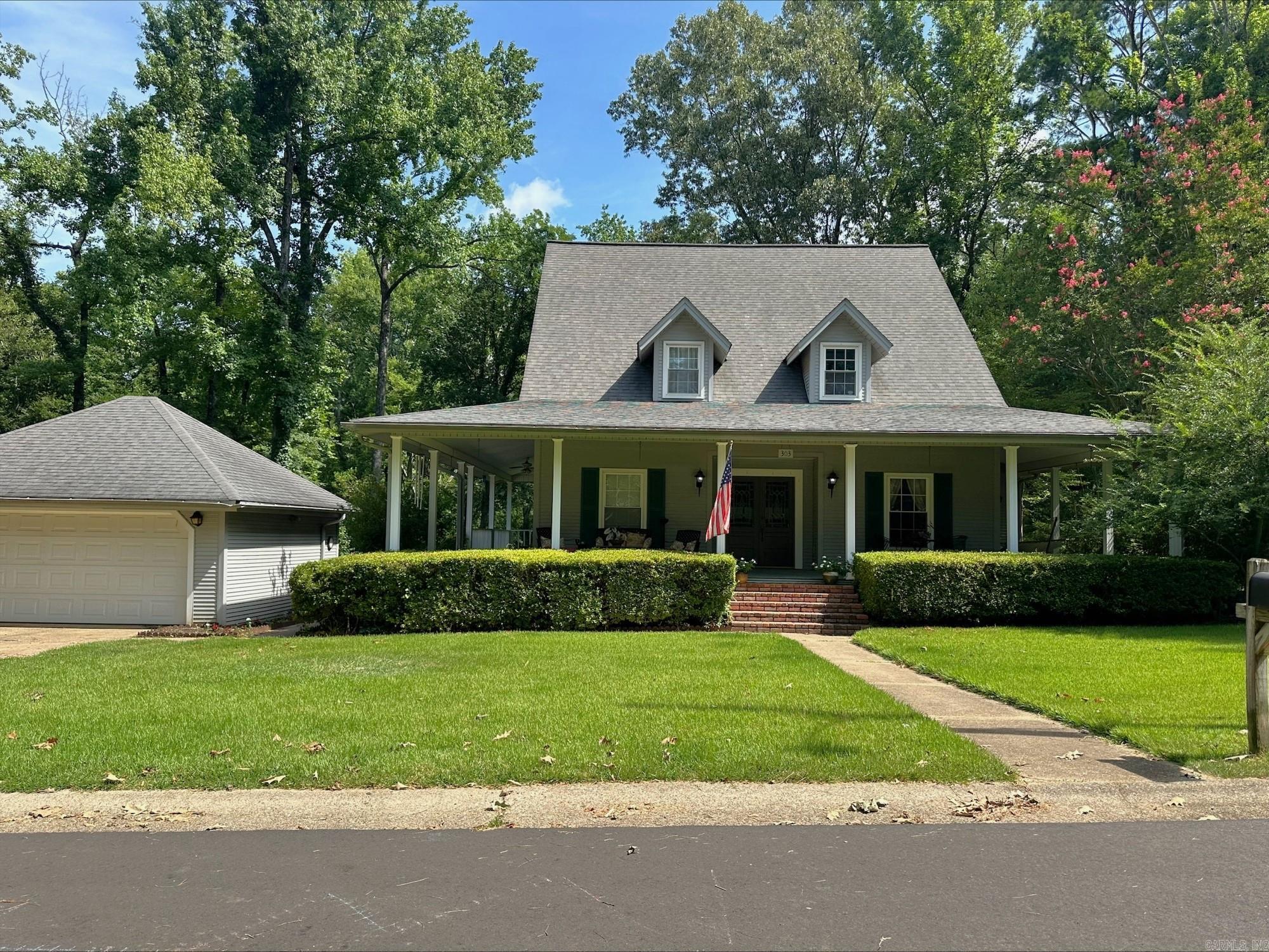 Beautiful home on a beautiful street! Don't miss this opportunity to dwell on the street where homes rarely sell. This 3 level home, has a 4th bedroom potential on the bottom level of the home where the half bath is located along with extra rooms for storage and extra living space. The primary bedroom, primary bath and common living and dining areas are on the main level of the home, with 2 other bedrooms sharing a large bathroom, are upstairs. All the bedrooms have spacious closets. The stunning porch wraps around the majority of the home with views of the well thought out landscaping. The detached garage has workshop space and access to a patio outback.
