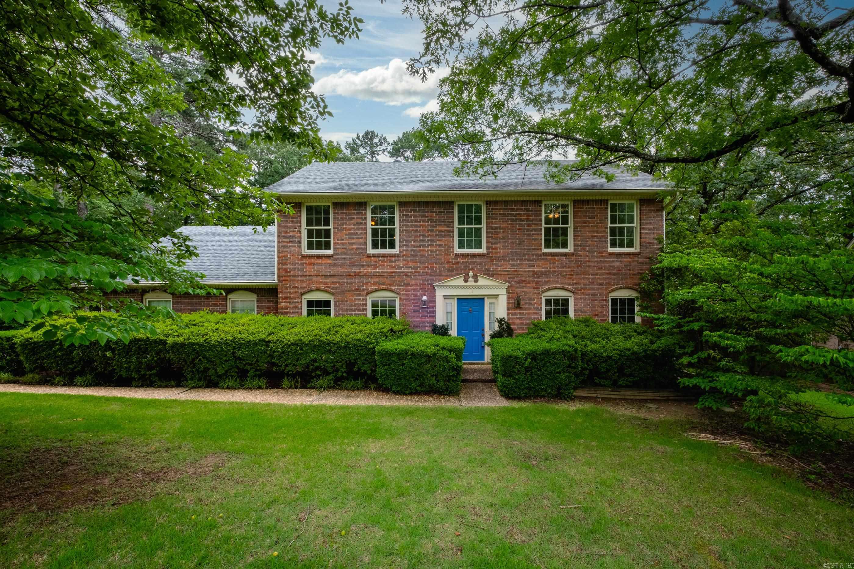 Spacious two story brick traditional on a large, beautifully landscaped lot with mature trees. The main level features a large primary suite with fireplace, formal dining room, living room that flows into the family room, or can be closed off with pocket doors, plus built-ins, a second fireplace, and a wet bar. Light and airy eat-in kitchen includes abundant cabinetry, parquet wood floors, double ovens, cooktop, microwave, and dishwasher. Laundry area and half bath also on main level. Upstairs offers a guest suite, two additional bedrooms, and a full hall bath. Enjoy the fully fenced backyard with lush landscaping, stone pavers, storage shed, and a deck perfect for relaxing or entertaining. Two-car side-load garage with storage closet. Roof replaced in 2018. A lovely home with excellent space inside and out, ready for you to make your own. Come see!