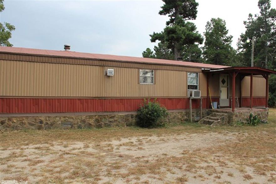 Located only 3.29 miles from Hwy. 65.  Setting is perfect for couple that likes to roam around outside and have a few chickens, livestock, and a garden spot.  The inside of the mobile home is very nice.   All fenced & cleared.  Several little barns & a couple little chicken houses and sheds.  There is a well.  Pump is not in working condition at present.  Property on Bee Branch Water.  Home has been completely repainted.  Main bath has new vanity, new flooring & new lights. Gas Heater in fireplace.