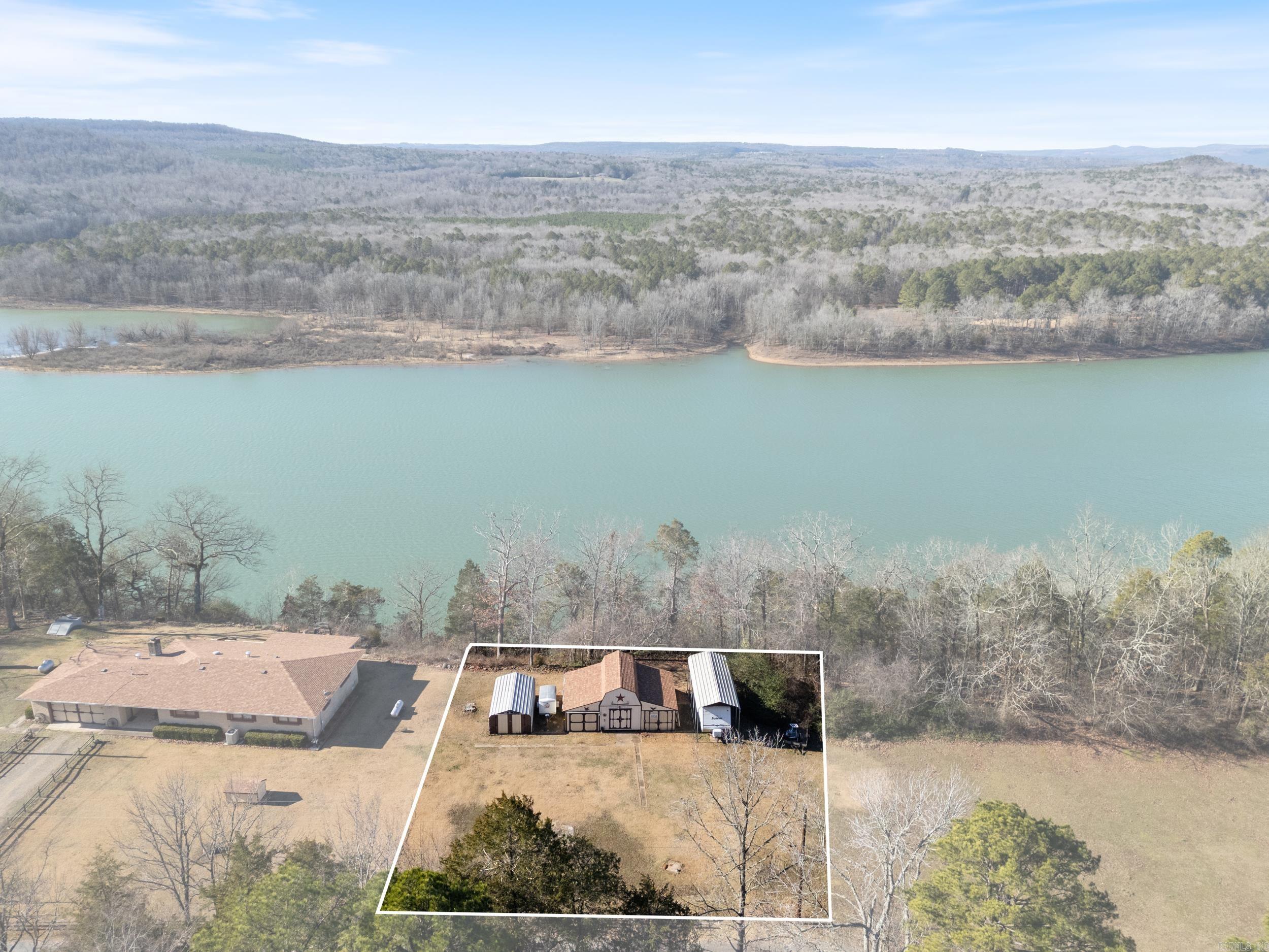 Build your dream cabin with breathtaking views of Greers Ferry Lake in the desirable Whispering Pines subdivision! This .56-acre lot offers stunning lakefront scenery and is the perfect spot for your weekend getaway or forever home. This lot provides panoramic views of the lake and has utilities conveniently located to make building simple. You also have the option to expand your property by purchasing additional adjacent lots. The property includes storage, a well, and an old septic system (not currently connected) no paperwork from the health dept. No mobile homes are allowed. Don’t miss this rare opportunity to own a slice of paradise with serene lakefront views. Whether you’re seeking a peaceful retreat or a place to gather with loved ones, this lot provides endless potential. Act now and start building your dream cabin today!