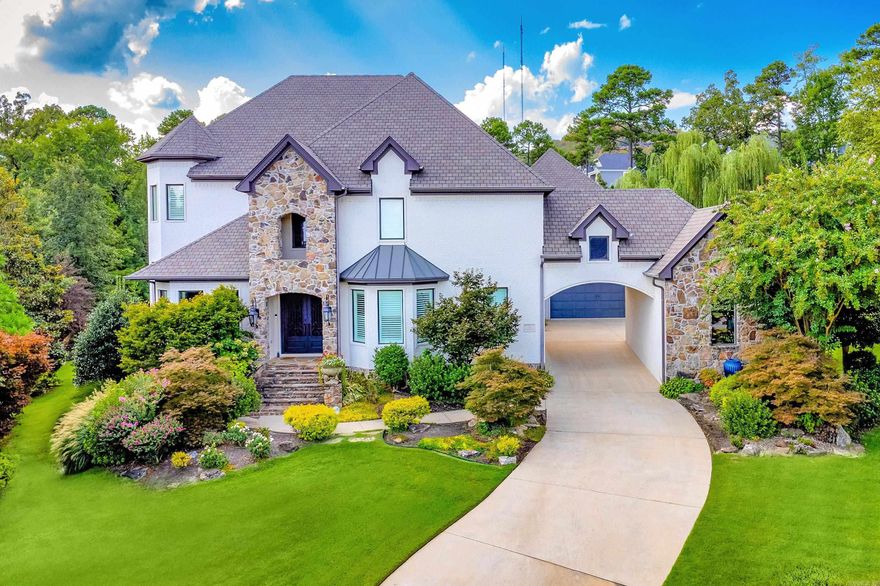 Situated on a beautifully landscaped lot in the coveted gated community of Deauville, this home offers luxury, comfort, and a perfect blend of indoor and outdoor living. Step inside to warm hardwood floors, soaring ceilings, and expansive windows that frame views of the covered outdoor living space, sparkling pool, lush gardens, and backyard pond. The perfectly designed floor plan includes: Great room plus both formal and informal dining areas, Chef’s kitchen with high-end appliances, gorgeous new countertops, and a stylish backsplash Private study and separate office for ultimate work-from-home flexibility Luxurious primary suite with a sitting area, spa-like bath, and massive closet Main-level guest suite with access to pool and patio Theater room with wet bar, new seating, carpet, and screen Custom wine room for the enthusiast Upstairs: two spacious guest bedrooms with shared bath, an en-suite bedroom, and  Additional highlights include: Three-car garage + golf cart storage Custom shades & plantation shutters Upgraded lighting and security system Added hardwoods throughout (no carpet) New pool heater, lights, and liner.  Refined living at its best.  COME SEE!!