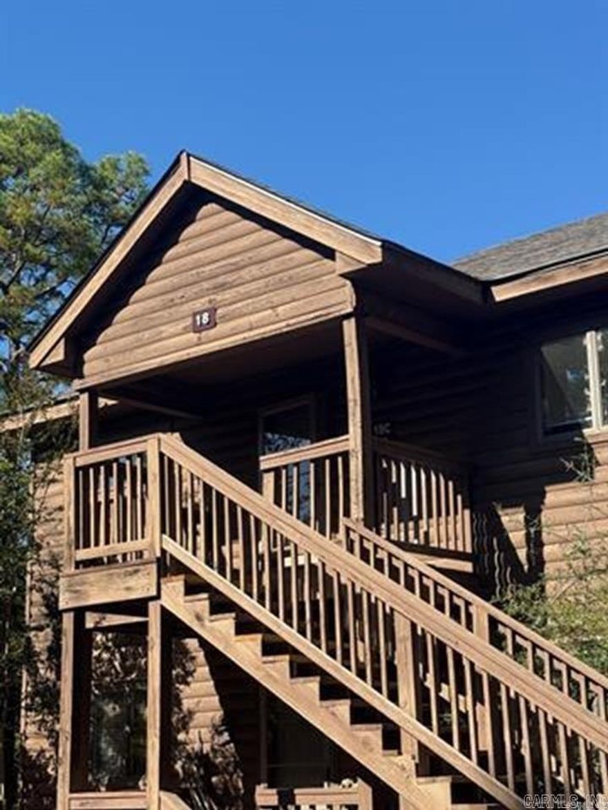 Step into this beautifully updated second-floor condo just minutes from Lake Ouachita. This move-in-ready retreat features a light-filled living area with vaulted ceilings, a cozy fireplace, and abundant windows that bring the outdoors in. The kitchen has been fully updated with new cabinetry, countertops, appliances, and an ice maker, while both bathrooms showcase new fixtures and refreshed showers. Fresh paint, updated flooring, and modern lighting flow throughout, creating a clean, cohesive feel. Enjoy peaceful wooded views from the private balcony, accessible from both the living room and the primary bedroom. All furnishings, TVs, and a Blackstone grill convey, making this an ideal full-time residence, weekend getaway, or turnkey investment opportunity.