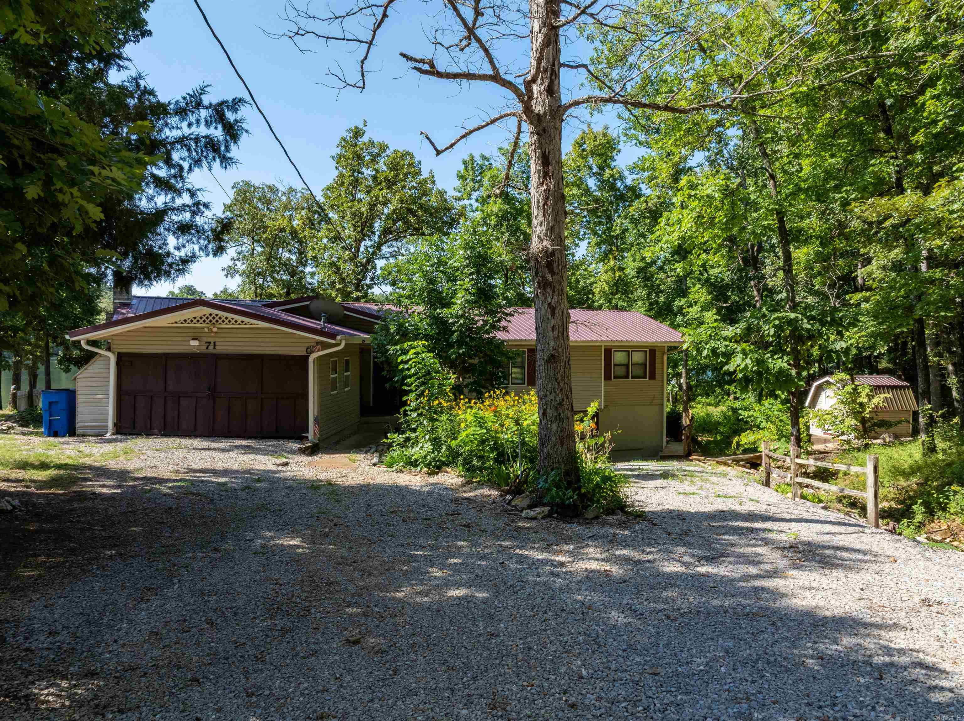Serene Lakeside Escape on Vagabond Lake ā Fully Furnished 3BR/2BA on 1.7± Acres Turnkey lakefront retreat located on the peaceful shores of Vagabond Lake near Hardy, AR. This beautifully maintained 3-bedroom, 2-bathroom home sits on a private 1.7± acre lot and offers stunning lake views, direct access to 100± acre Vagabond Lake, and incredible outdoor living space. Perfect as a full-time residence, second home, or income-producing vacation rentalācurrently used as both. Enjoy a spacious multi-level deck with outdoor seating, two private docks, and included kayaks and a canoe. Relax by the fire pit or cook out on the gas grill. Inside, the open floor plan features Smart TVs, cable, books, board games, and a fully equipped kitchen with modern appliances. Sleeping arrangements include two queen bedrooms and a third bedroom with twin beds and trundlesācomfortably sleeping 8. Additional features: private fenced yard, free WiFi, central A/C, keyless entry, beach towels, and more. Located minutes from Mammoth Spring State Park, Southfork River, and historic Downtown Hardy. No jet skis permitted; 70 HP boat limit maintains the quiet, family-friendly environment. Sold fully furnished.