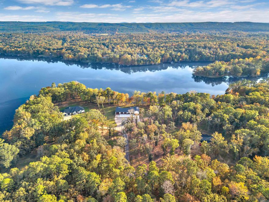 This stunning Harris Brake lakefront property is truly one of a kind and must be seen to be fully appreciated! Sitting on 3 beautiful acres with approximately 500 feet of lake frontage, this serene retreat is surrounded by new custom-built homes in a quiet rural subdivision—tucked far away from the main road for ultimate privacy and peace.  This property is perfect for the retired traveler, who needs a place to call home and wants a place to park their motor home while taking time off the road - with a build site for a guest cottage or main home already set! All utilities are easily accessible and setup in place to hook up to with ease.  The existing house/shop combination features 3 bedrooms, 1 bathroom, and gorgeous custom finishes throughout. The spacious living room showcases tall ceilings and a tasteful blend of modern design with rustic barnwood and stone accents.  The attached shop is a dream setup, featuring three 8’ motorized garage doors, two 10’ manual garage doors, and a 14x14’ door designed in mind for your RV. The back porch is prewired for a hot tub, and there’s even an RV hookup along the side of the home—perfect for visiting friends or family!  Buyer can add dock.