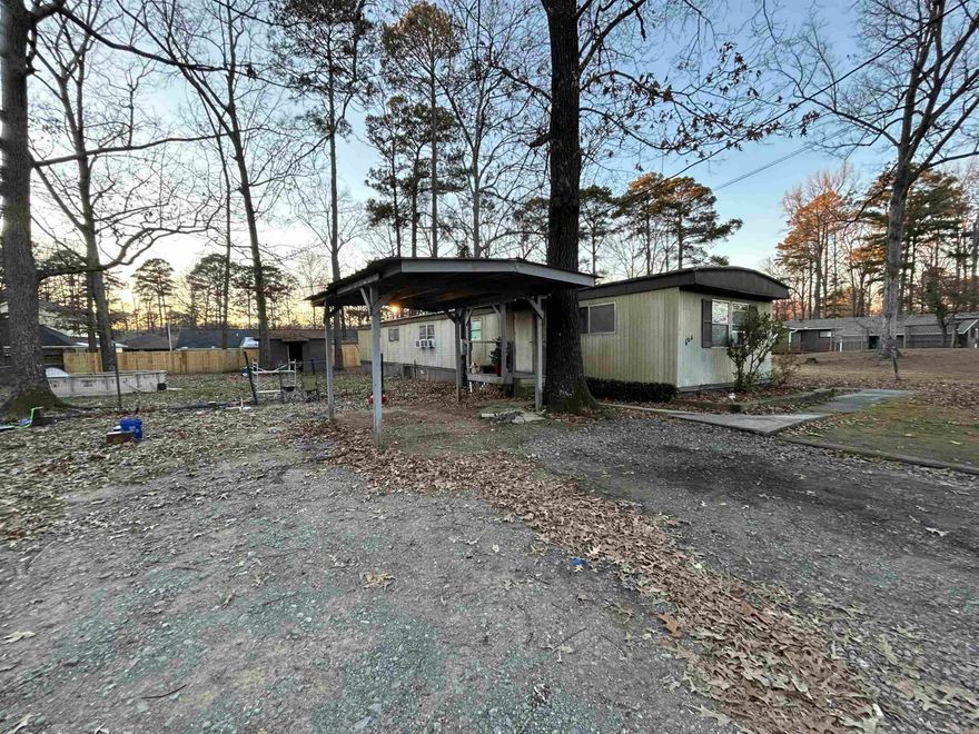 Investor special..Property being sold AS-IS. This older mobile home has had lots of work done throughout, with new floors, a new island, backsplash, and more. All new appliances in kitchen and laundry area. Fenced in backyard and a carport! Recently enclosed front porch, can be undone by seller. LOCATION LOCATION LOCATION!!!