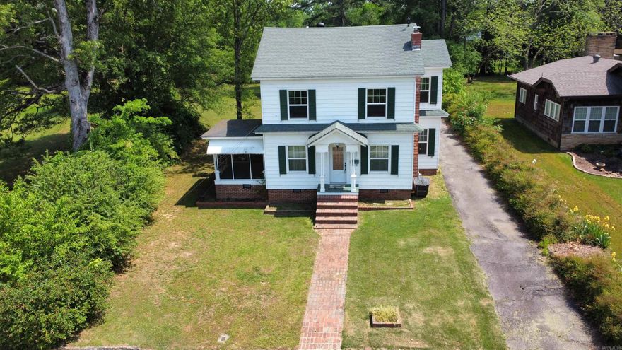 Step into a piece of history with this charming three-bedroom, two-bathroom home in the heart of downtown Clarksville. Original wood floors, soaring ceilings, and large windows infuse the space with classic elegance and natural light. The spacious kitchen is a culinary dream, offering abundant room for cooking and gatherings. Enjoy serene moments on the screened-in porch overlooking downtown Clarksville or entertain on the covered outdoor patio. A generous shop provides versatile space for hobbies or storage. This unique property is a true gem, offering the perfect blend of historic character and modern convenience."