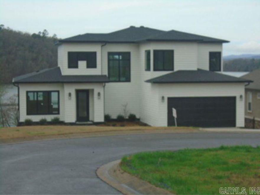 Welcome to your new two-story modern home in the exclusive Oakridge Lake Estates gated community. This stunning property features a cathedral ceiling entrance with unique bohemian-inspired lighting, a sleek kitchen with quartzite countertops, top-of-the-line appliances, and a spacious family room with panoramic views of Lake Hamilton.