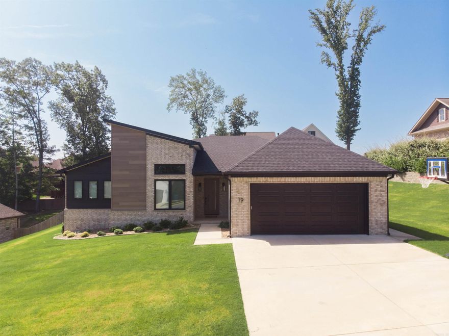 19 Sagamore Court – A Custom Built Home with Exceptional Upgrades in the Heart of Maumelle Located on a quiet street in central Maumelle, this modern 4-bedroom, 3-bathroom home built by Hines Homes sits on a spacious 0.42-acre lot and is loaded with premium upgrades. This is truly a one-of-a-kind residence that blends clean, modern style with functional design. The open floor plan features high ceilings, designer lighting, custom mirrors and glasswork, and upgraded finishes from top to bottom. The spacious kitchen boasts high-end cabinetry, a large island perfect for entertaining, and even includes a dedicated space for a secondary refrigerator. A beautifully appointed office space offers peace and privacy. The oversized primary suite feels like a retreat, and the luxurious en suite bath features stunning custom touches. Practicality meets luxury with features like full stair access to a large attic space directly from the garage. The backyard provides ample room to relax, entertain, or let kids and pets play, all just minutes from parks, schools, shopping, and dining. Schedule your tour today!  Broker has familial relationship with seller. Agents see remarks