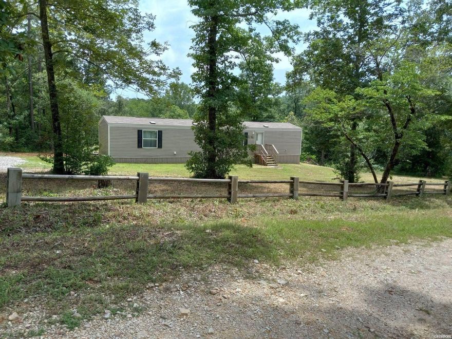 Wildlife abounds on this secluded property in Lake Hamilton School District! This property has a newer, energy efficient manufactured home sitting on 13.22+/- acres with the Little Mazarn Creek running across the back of the property. Peaceful and secluded setting with multiple building site possibilities. It has its own private cul-de-sac with an already installed fire hydrant and accessible electric. This home is on a septic system and has Kimzey water. Don't miss an opportunity to make this property your own!