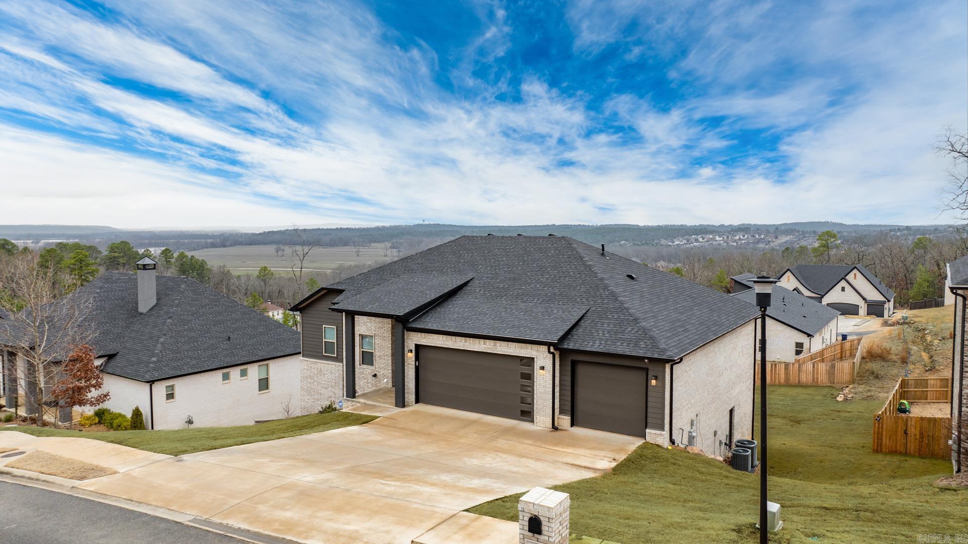 Stunning like new home built in 2024 with breathtaking sunset views! The open concept design features a spacious living area with an upgraded gas Heatilator fireplace and expansive windows across the back, filling the home with natural light. The gorgeous eat in kitchen and dining area is perfect for entertaining and includes custom cabinets, upgraded GE Cafe appliances, a large center island, and a walk-in pantry. The main level primary suite offers a luxurious double walk in shower, soaker tub and a huge closet also accessing the laundry room. A dedicated office/study area adds versatility. The lower level features three bedrooms, two baths, a bonus/game/flex room, and an unfinished expansion space off the bonus as well separate storage room with outdoor access. Enjoy spectacular views from the main level deck and lower level covered patio overlooking the large yard. Three car garage, tankless HWH and top of the line security system. Come see!