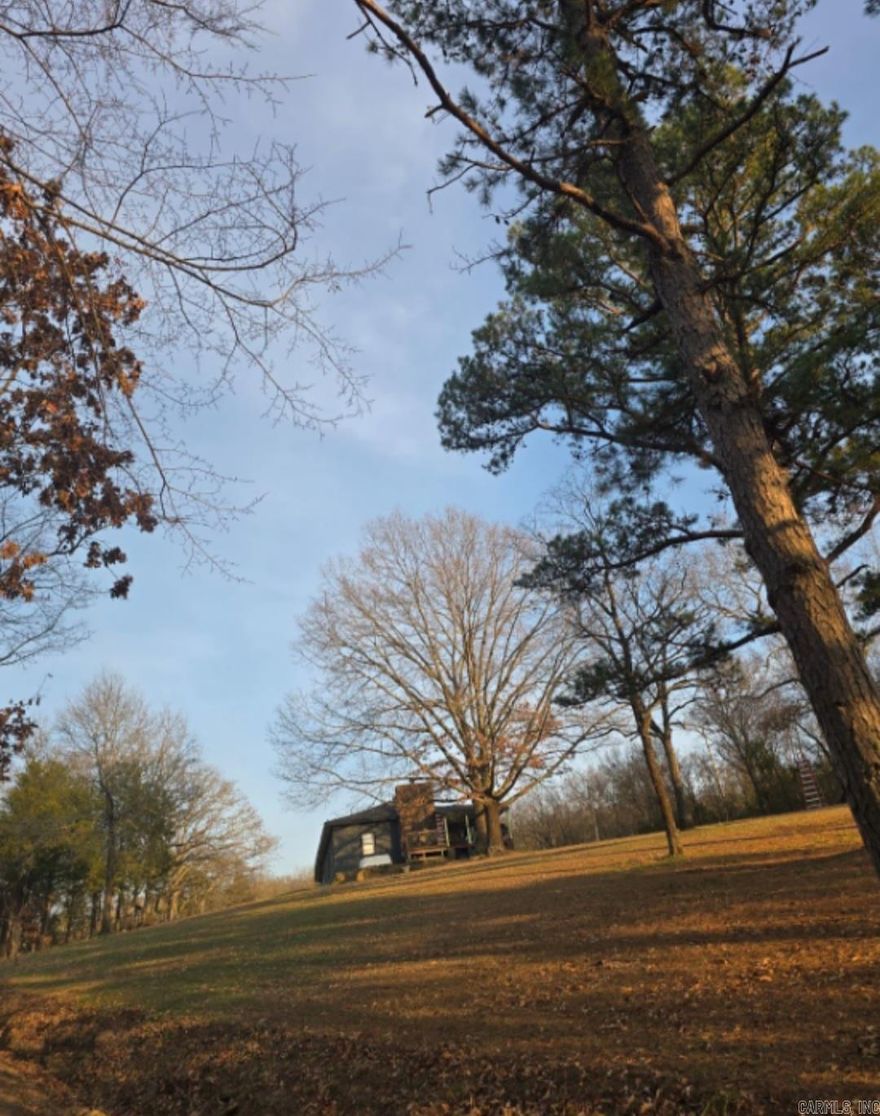 Bring your toolbelt! This 3-bed, 2-bath home is ideal for those seeking space, privacy, and a project with rewards. The house offers solid bones as it sits tucked away peacefully on 5 (+/-) acres. Giving the home rustic character includes a warm wood-burning fireplace, perfect for cozy evenings after a day of outdoor living. With some TLC, this private and secluded residence could be transformed into the perfect country retreat.