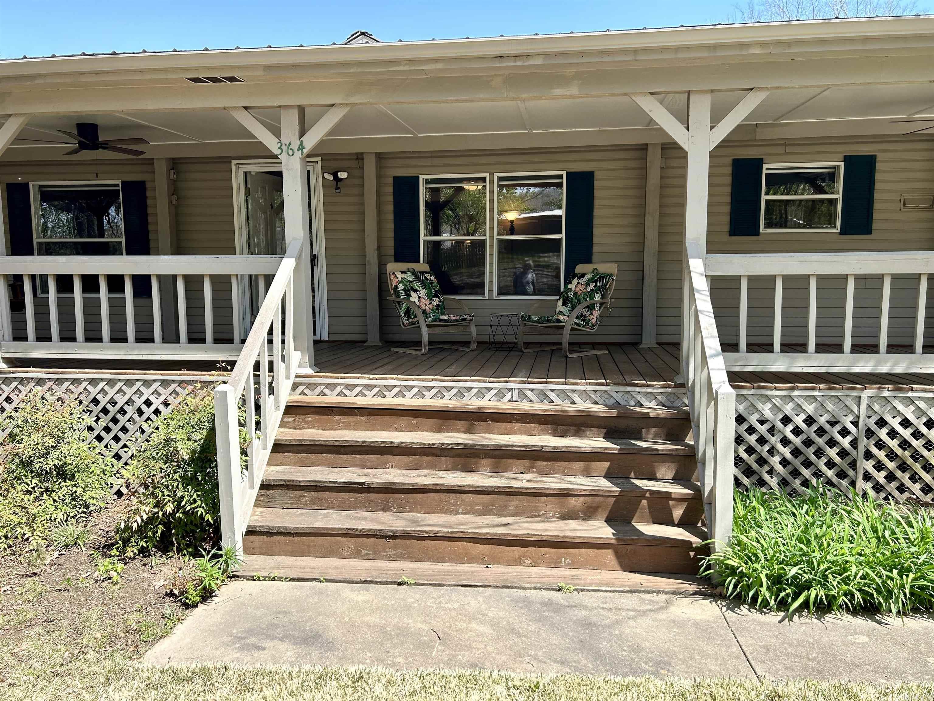 This home checks the boxes for convenient country living! - Well maintained 3 bedroom, 2 bath home - 1.67 acres - 1 mile to the Courthouse Square - 24 x 36 foot shop building - 2 car carport with additional storage - Covered RV storage - Additional RV parking pad with hookups - Small storage building or future "she shed" - New roof on house and shop in 2024 - New luxury vinyl plank floor throughout - New countertops - New appliances - All appliances including refrigerator, washer and dryer convey - Large, wrap around porches for outdoor relaxing and entertaining - Beautiful landscaping with lots of room for a large garden, chickens, and even another critter or two. - Unrestricted, just out of city limits. - This is a truly wonderful property from which to enjoy all that Mountain View and the Ozark Mountains have to offer!